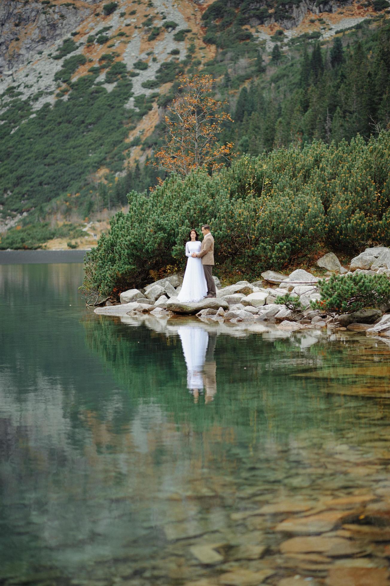 Loving couple on the background of the Sea-eye lake in Poland Stock Free