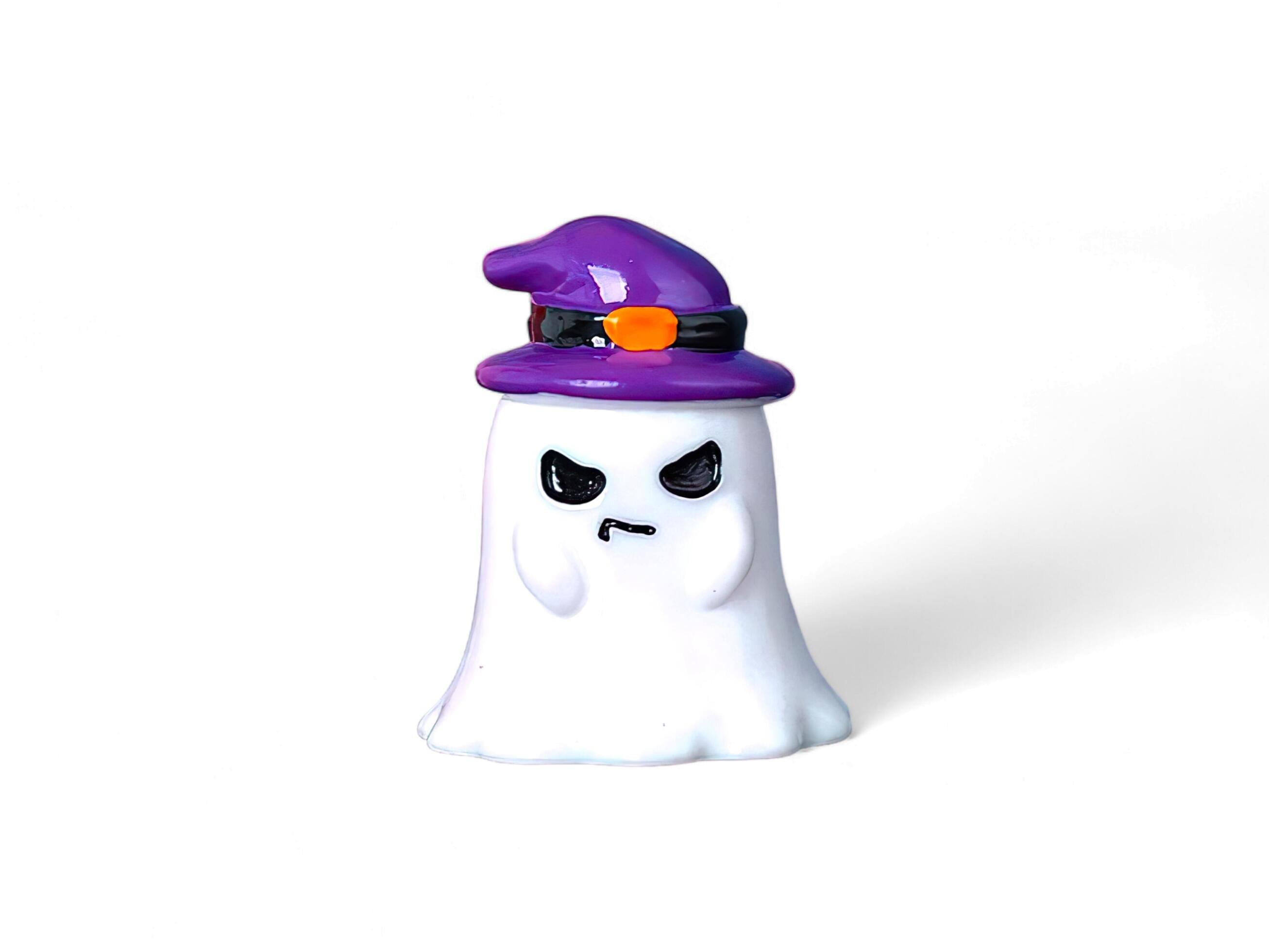 Decorated miniature ghost wearing a hat on a white background Stock Free