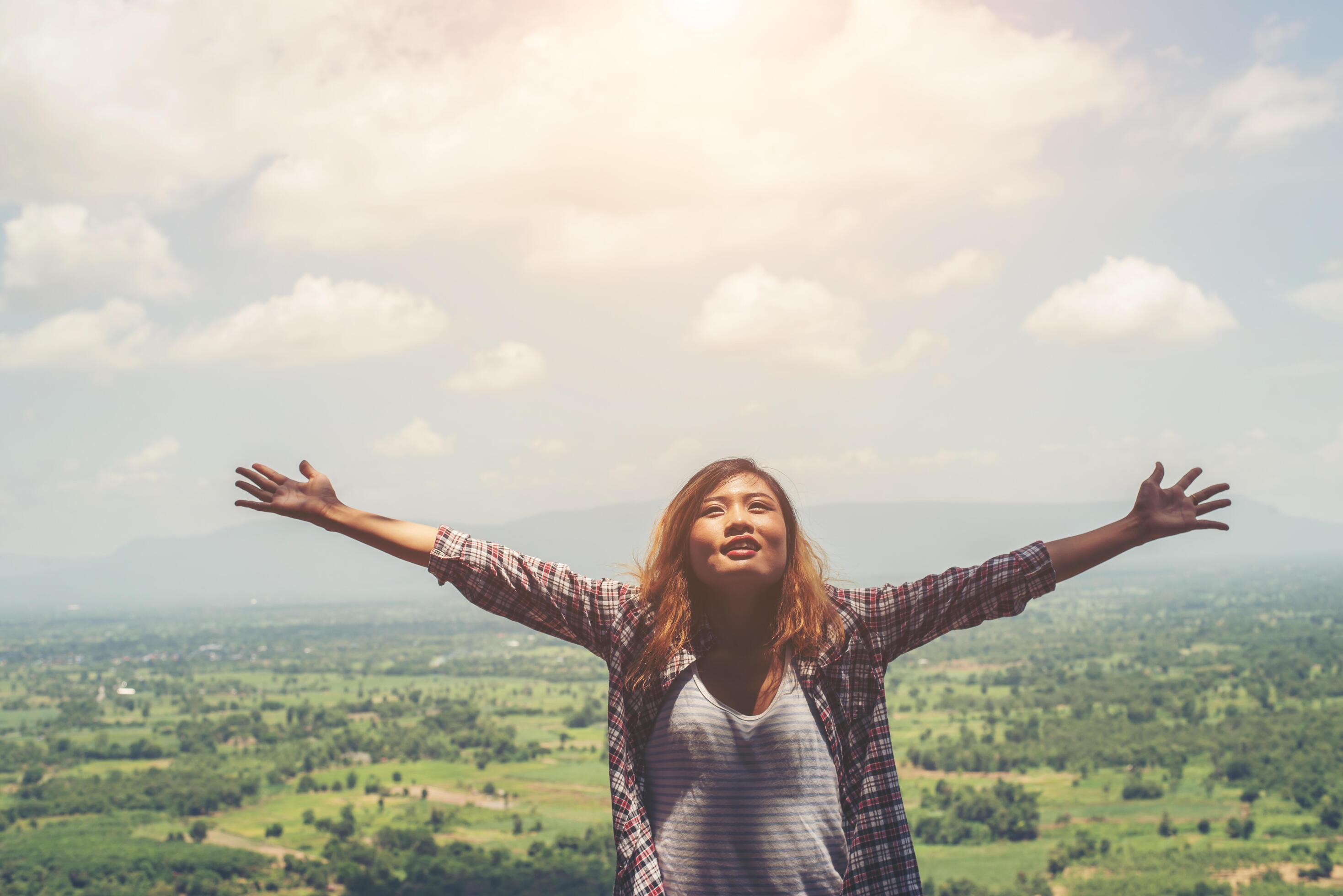 Young hipster woman standing alone outdoor with wild forest mountains on background Travel Lifestyle. Stock Free