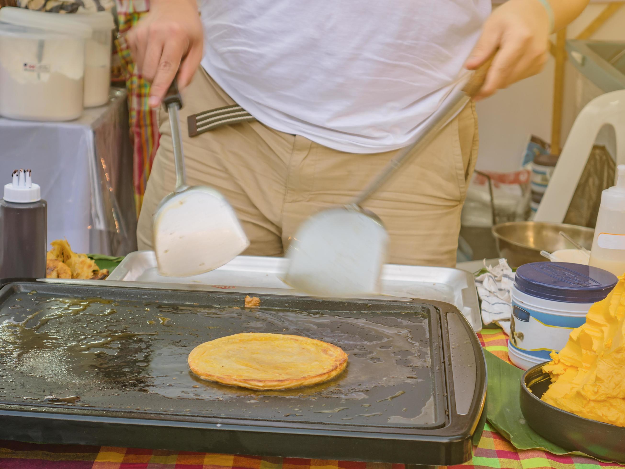 Cooking Roti in the Food stall of bazaar on the street Stock Free