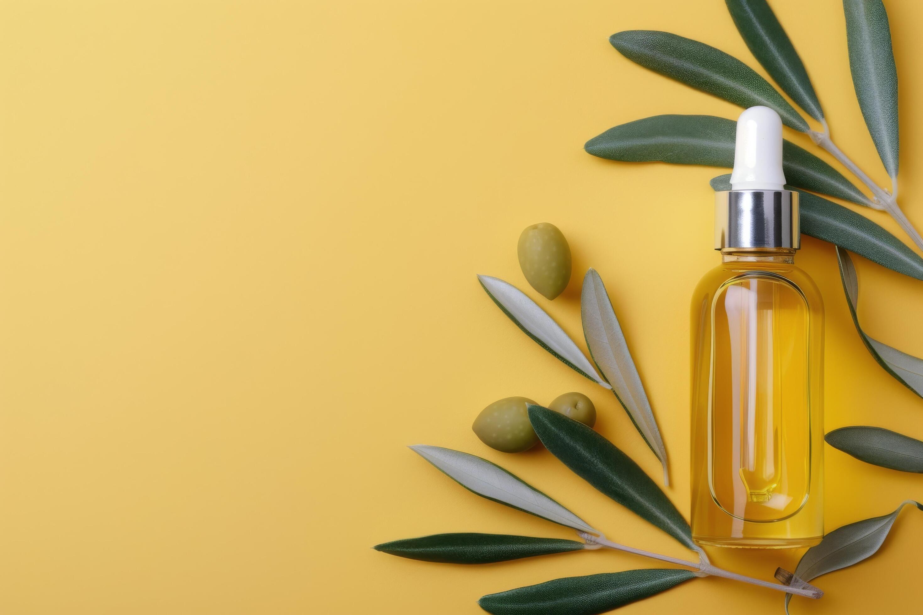 Olive Oil Bottle With Leaves on Yellow Background Stock Free