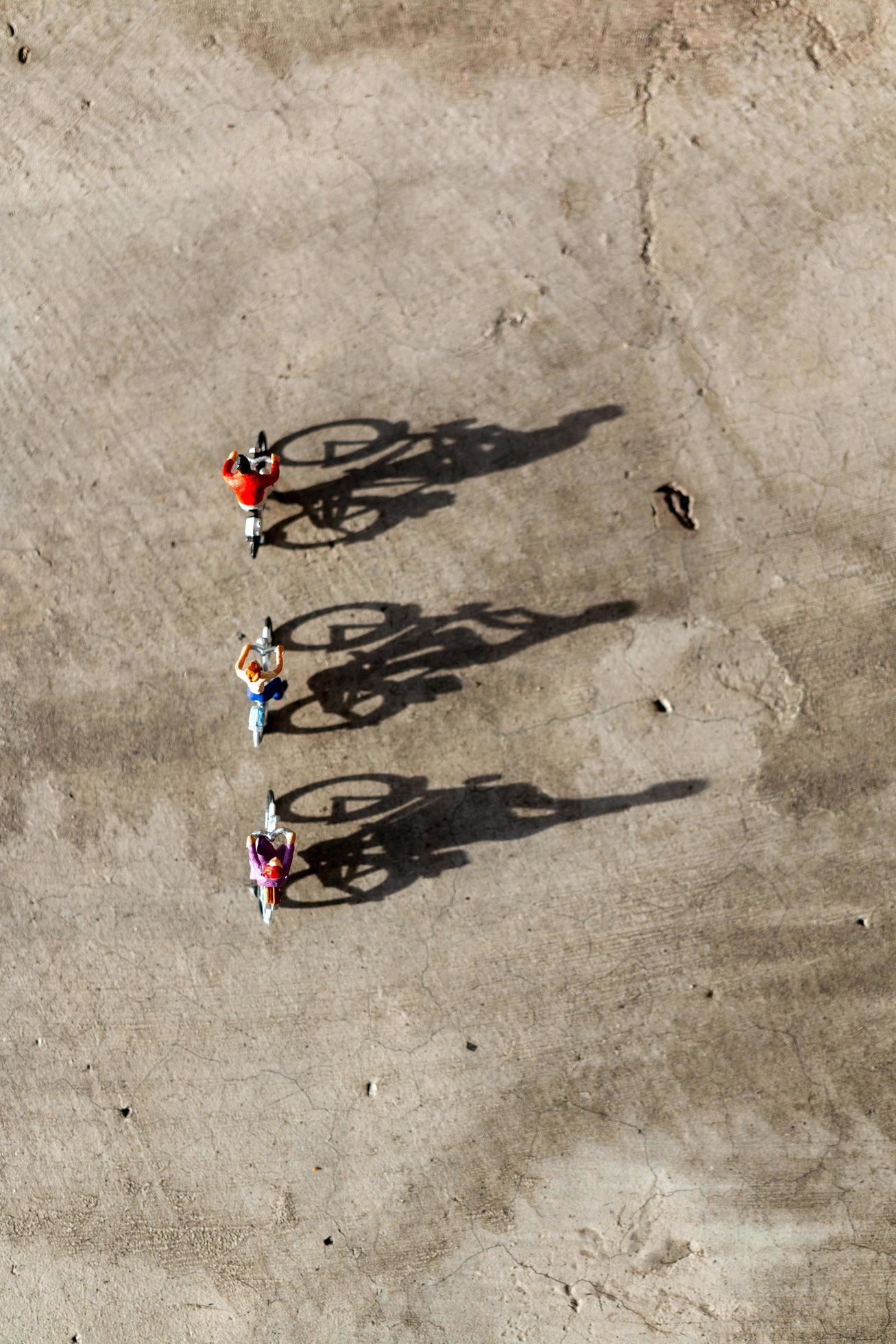 Miniature travelers riding bicycles, healthy lifestyle concept Stock Free