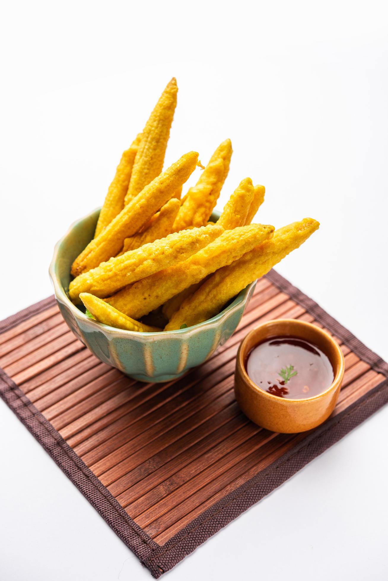 Crispy fried baby corn pakoda, pakora or Baby corn fritters served with ketchup, Indian food Stock Free