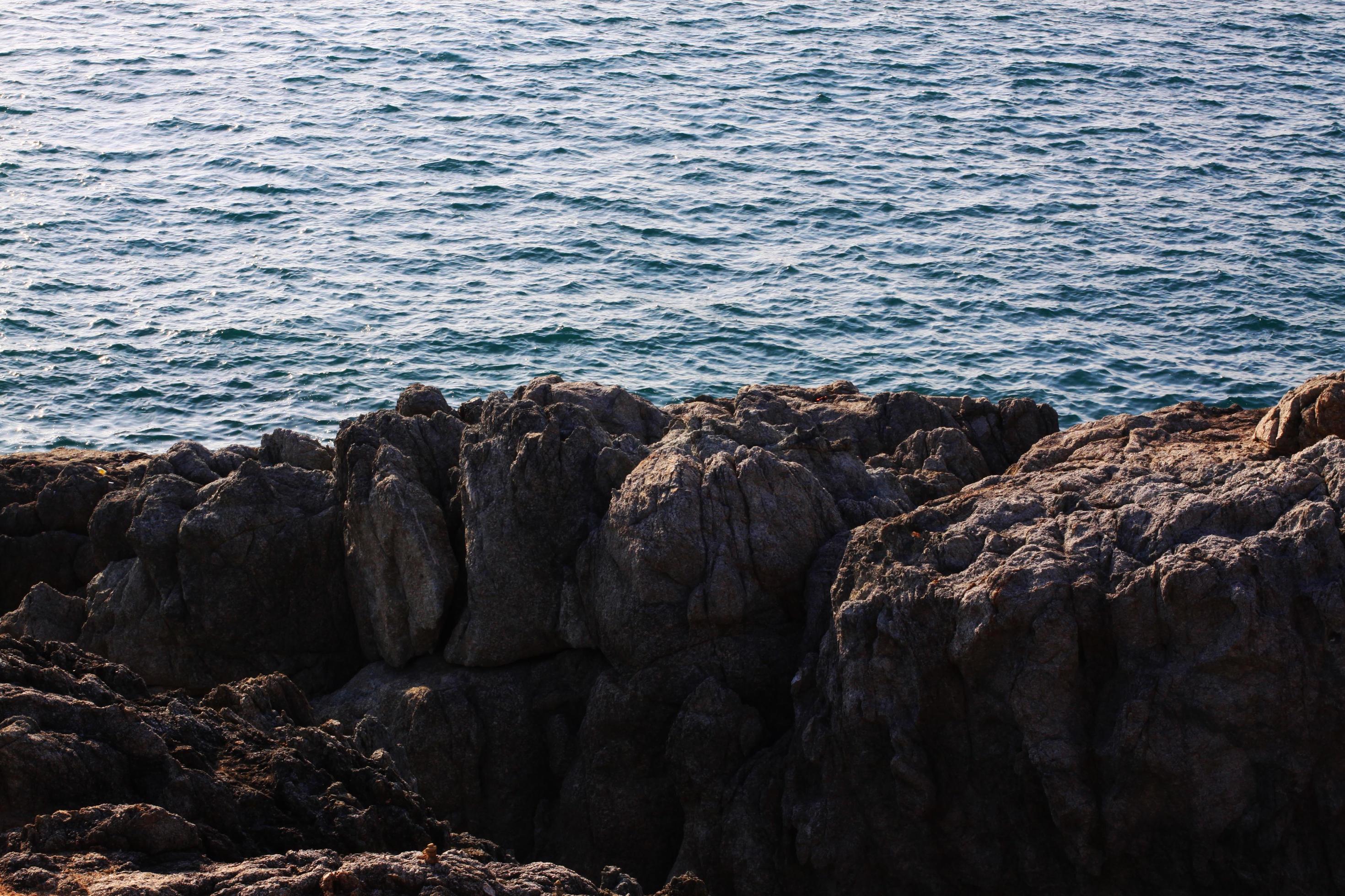 Beautiful seascape with sunset and sea horizon with Calm and rock Cape in Phuket island, Thailand. Stock Free