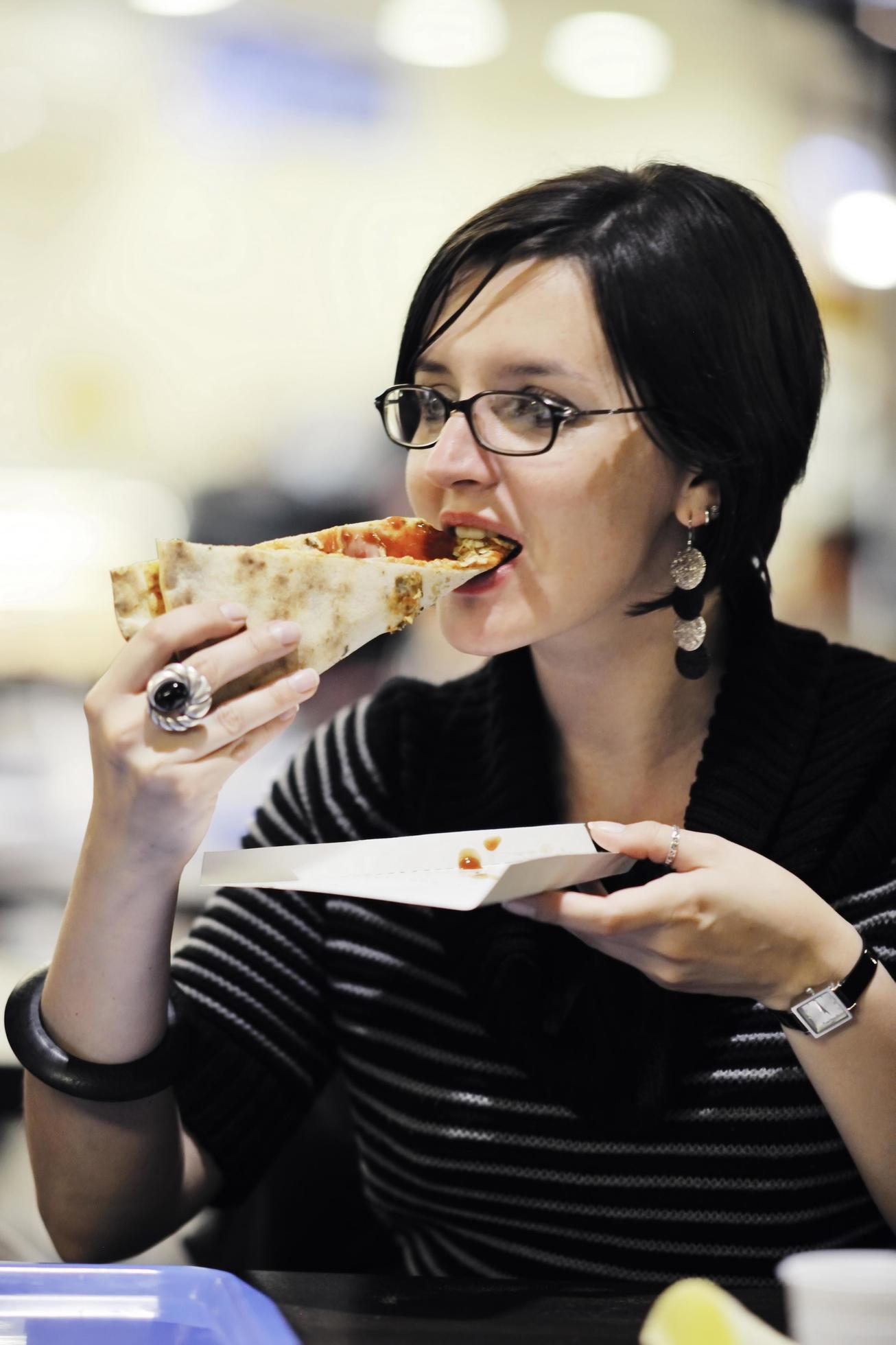 woman eat pizza food at restaurant Stock Free