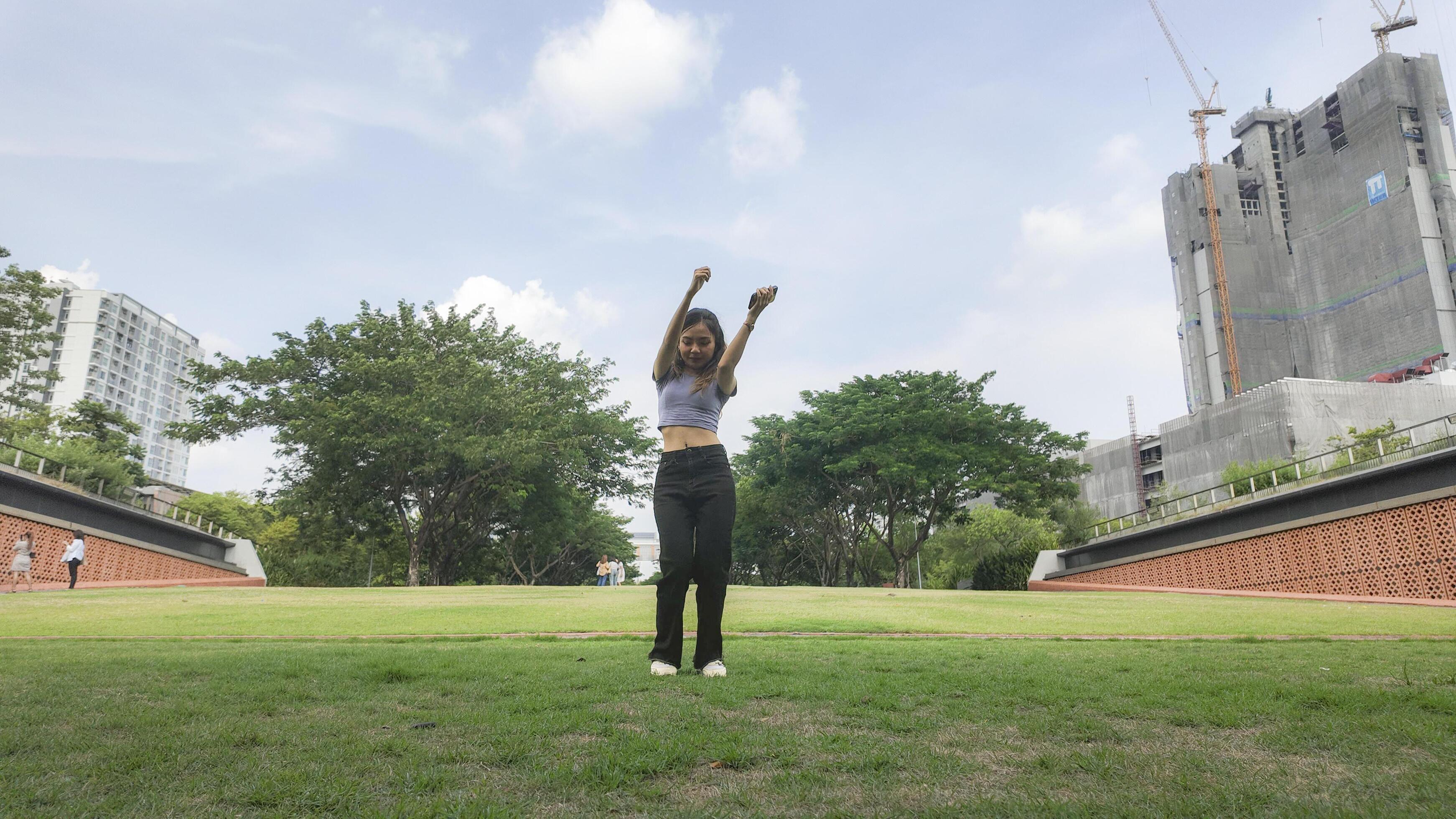 Asian women do freestyle hip hop and breakdancing in a public space in the middle of the city. With a cheerful and happy attitude Stock Free