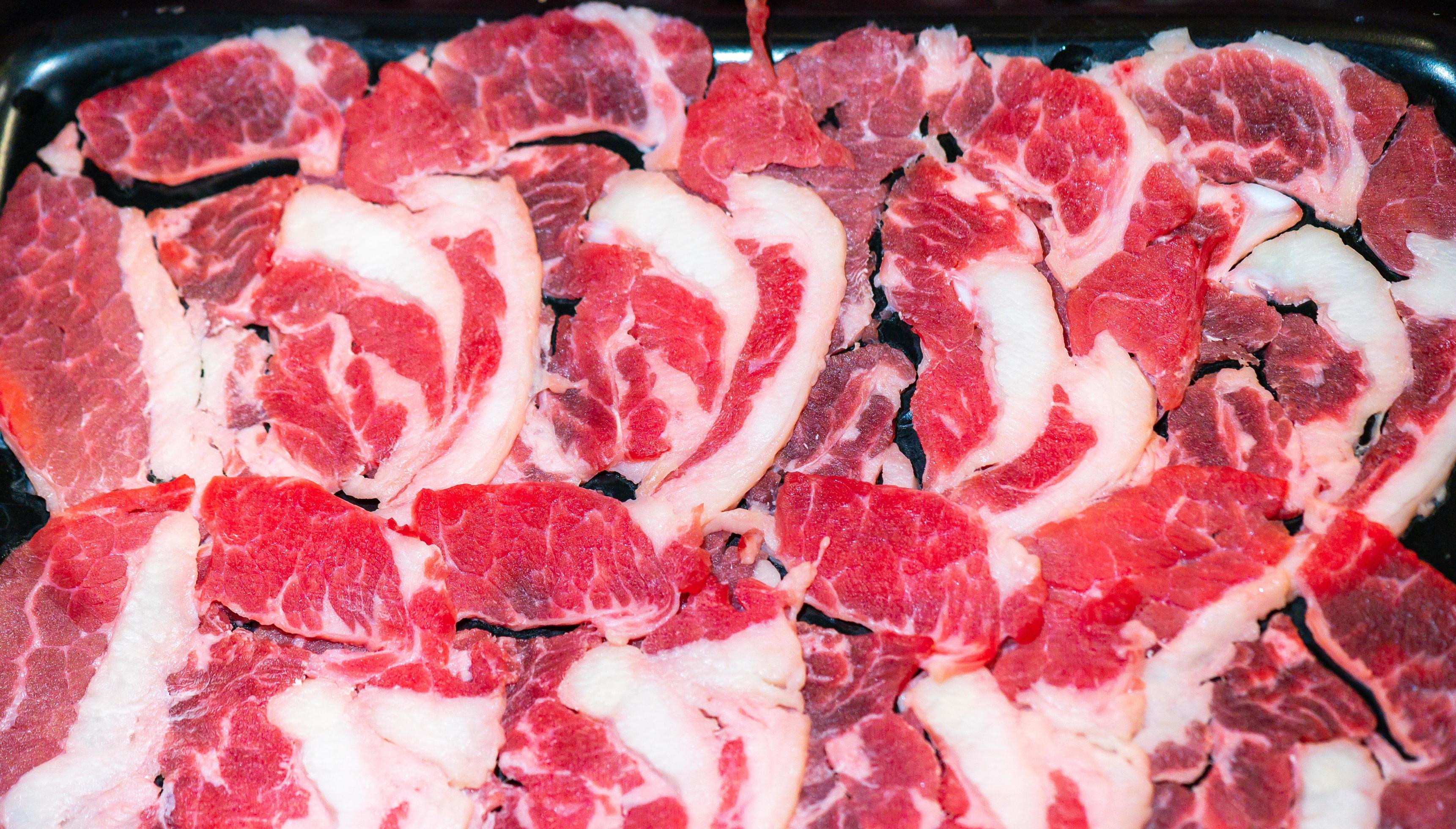 Slide raw beef for Yakiniku. Thin piece beef for Shabu hotpot japanese food style. Close up fresh meat chuck eye for Sukiyaki. top view Stock Free