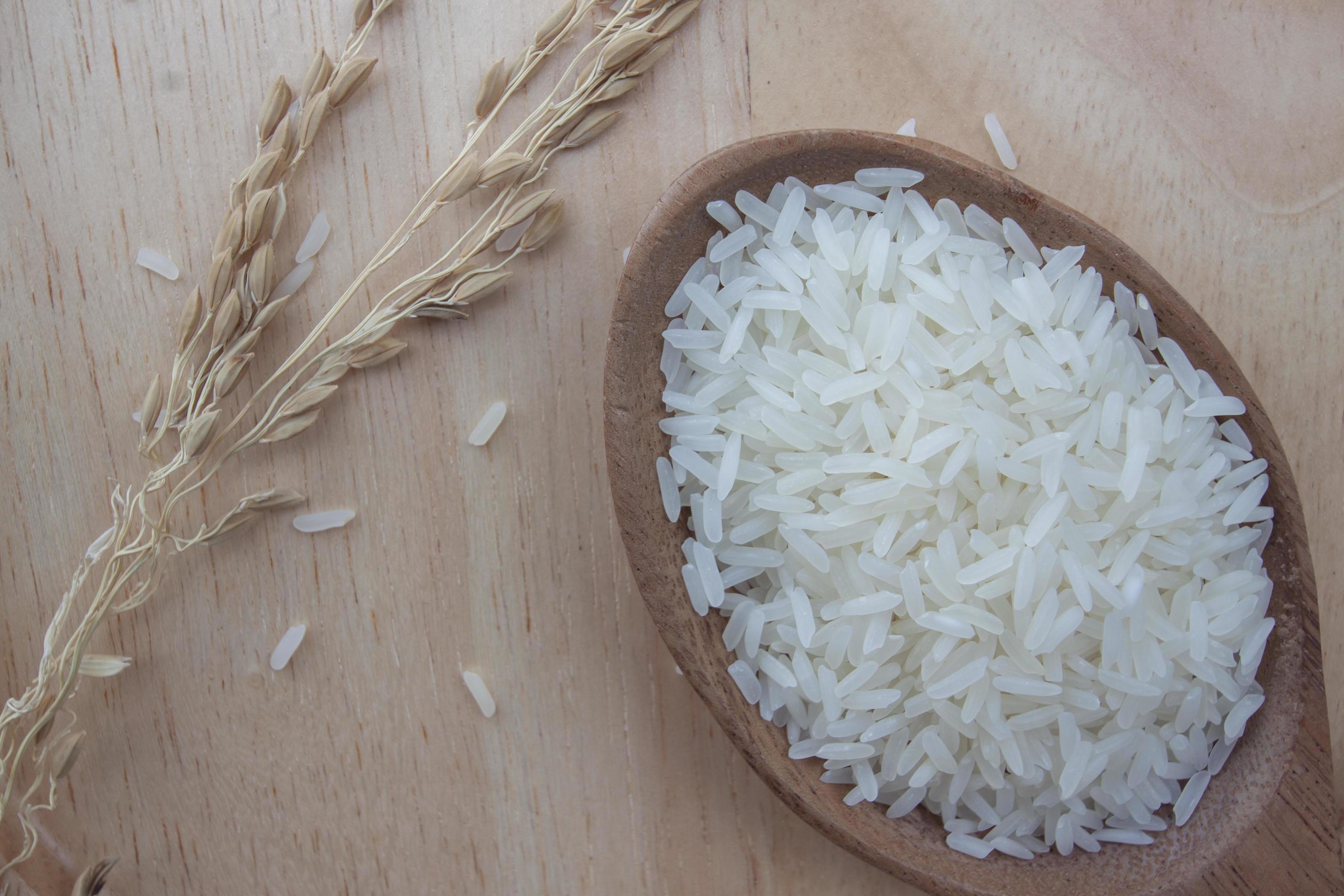 Top view of Rice is the main food of Thailand. Placed on wooden table background. Stock Free