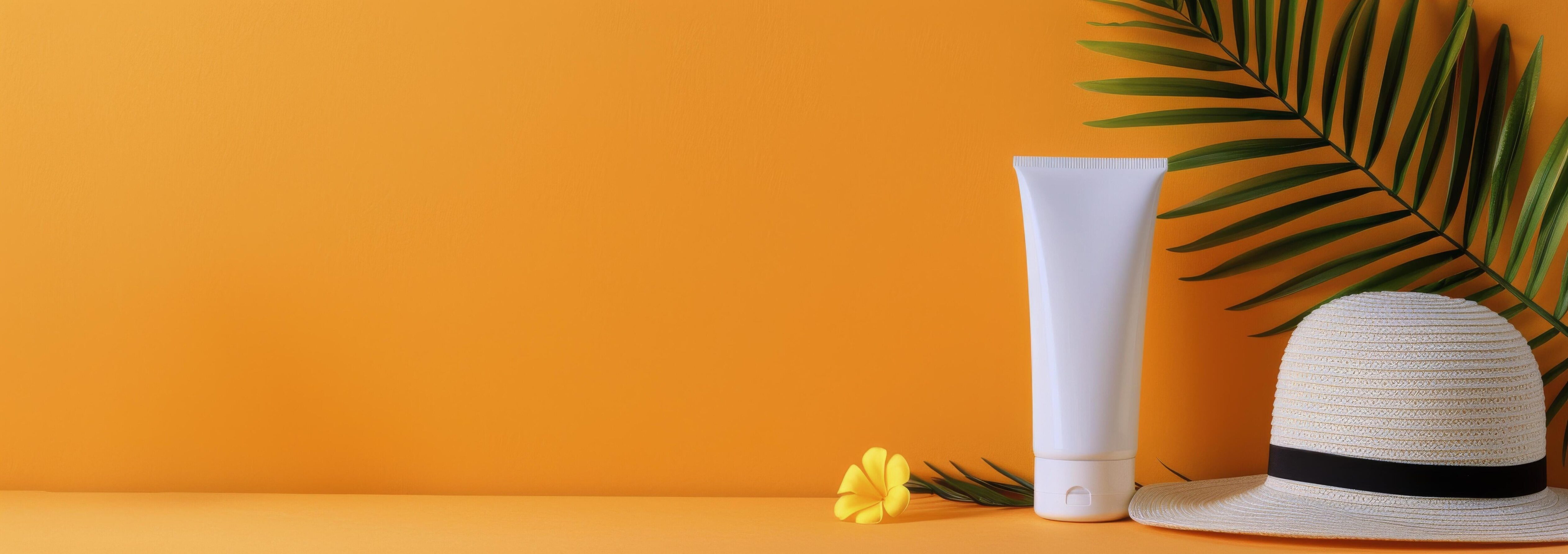 Summer Hat and Sunscreen on an Orange Background With Palm Leaves Stock Free