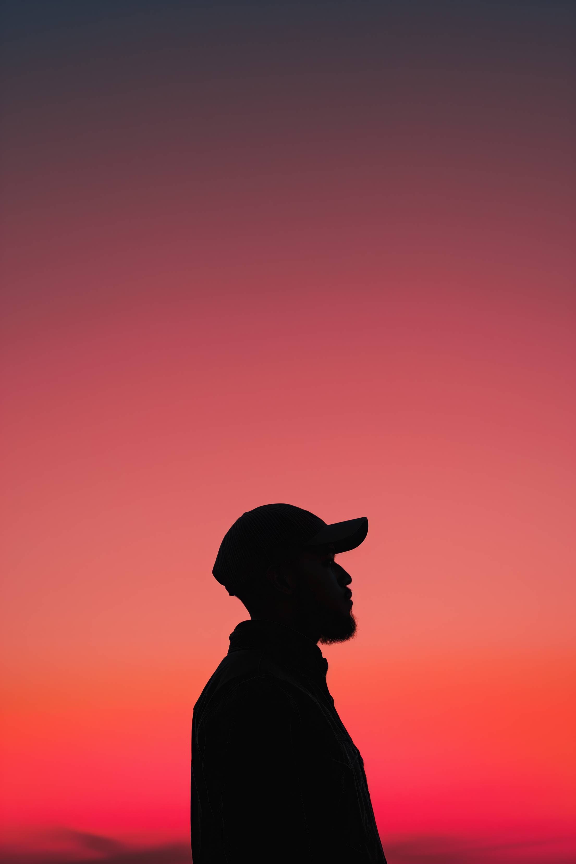 Silhouette of a Guy With a Cap at Red Sky Sunset Stock Free