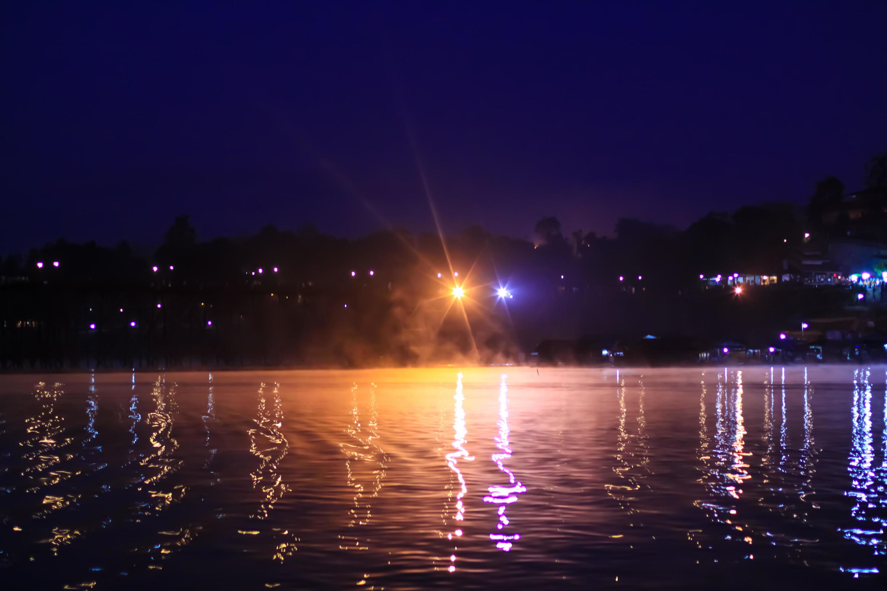 Beautiful Bokeh light and fog over river in the morning at countryside of Thailand Stock Free