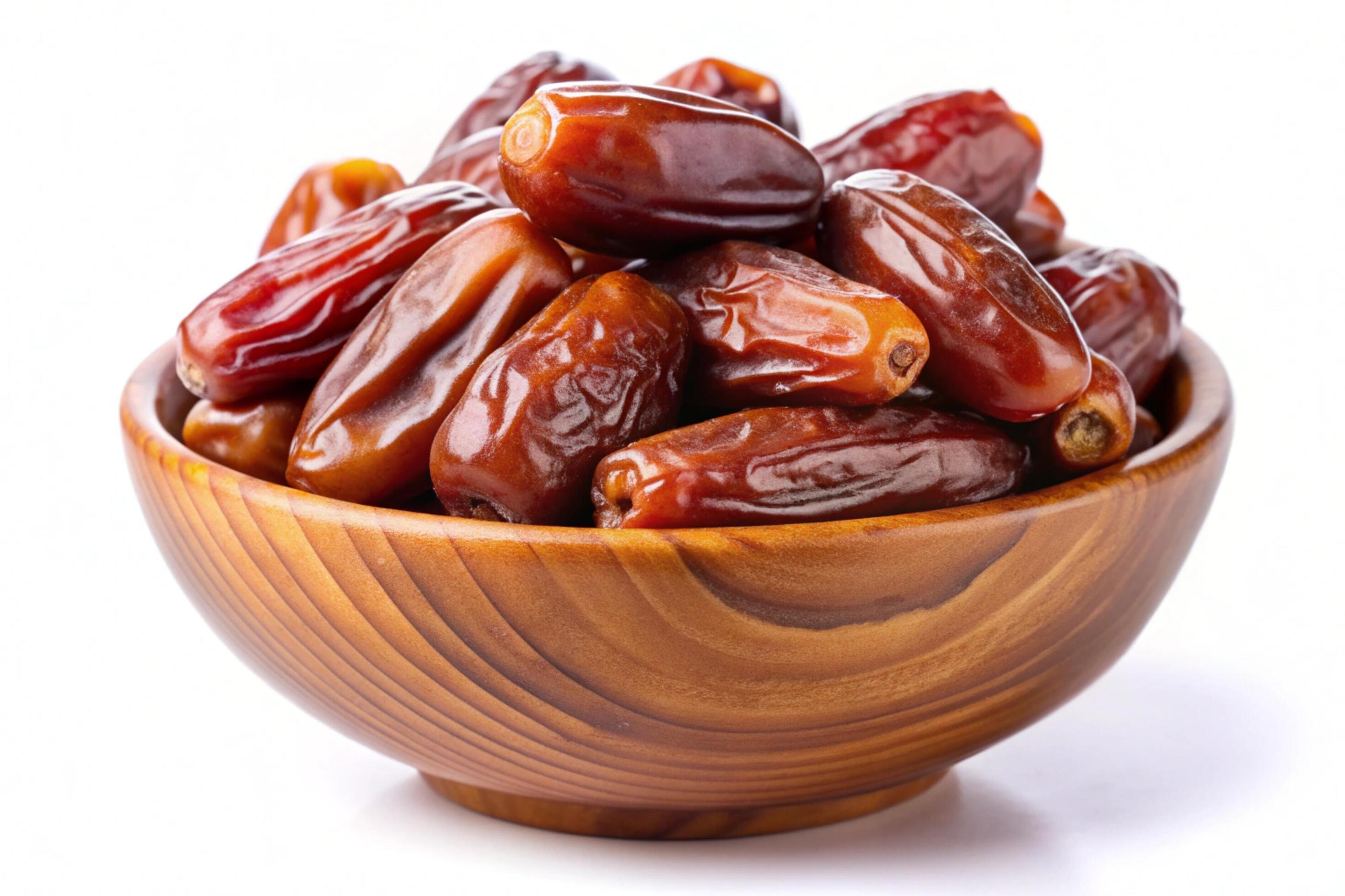 Dates in wood bowl isolated on white background Stock Free