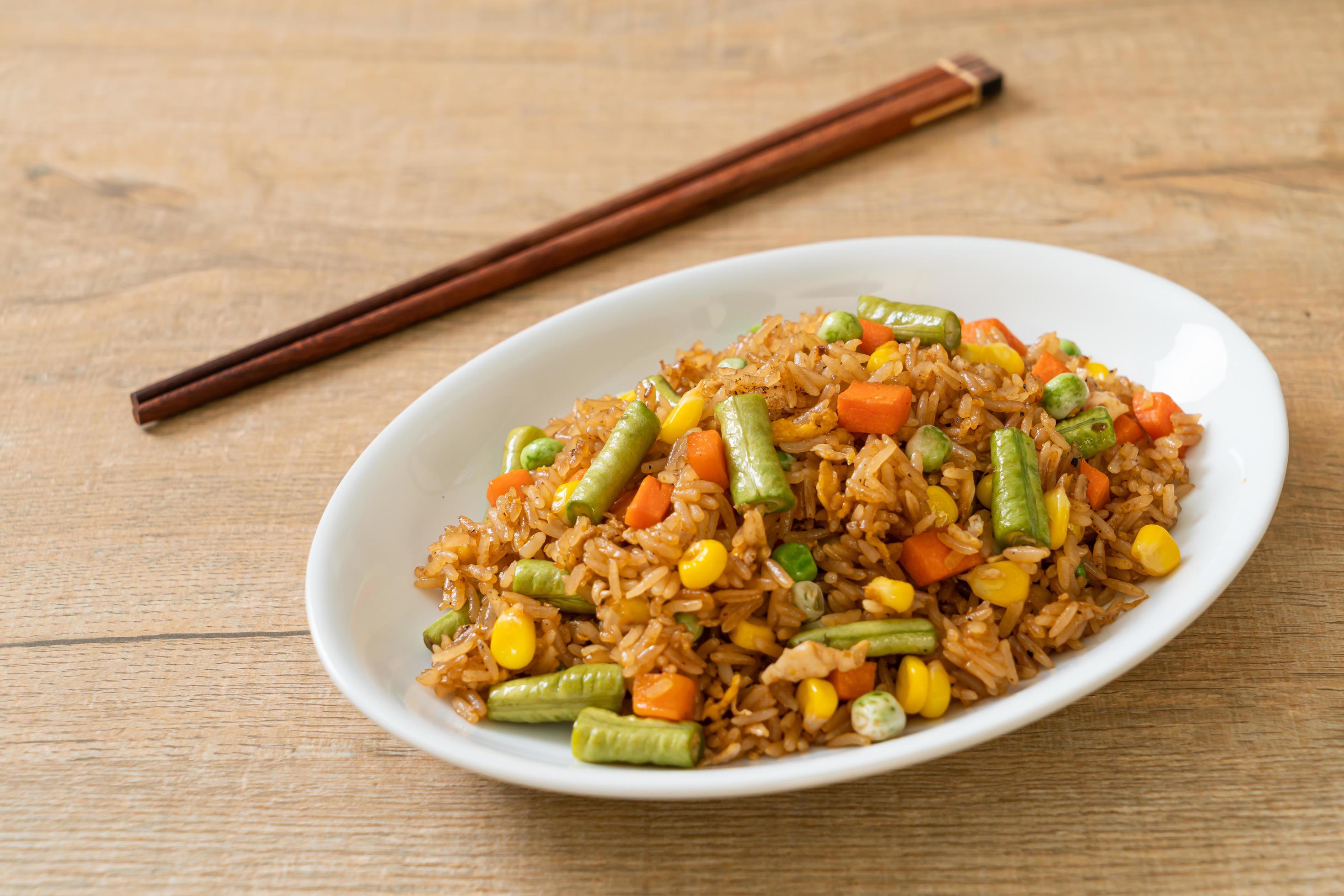 Fried rice with green peas, carrot and corn – vegetarian and healthy food style Stock Free