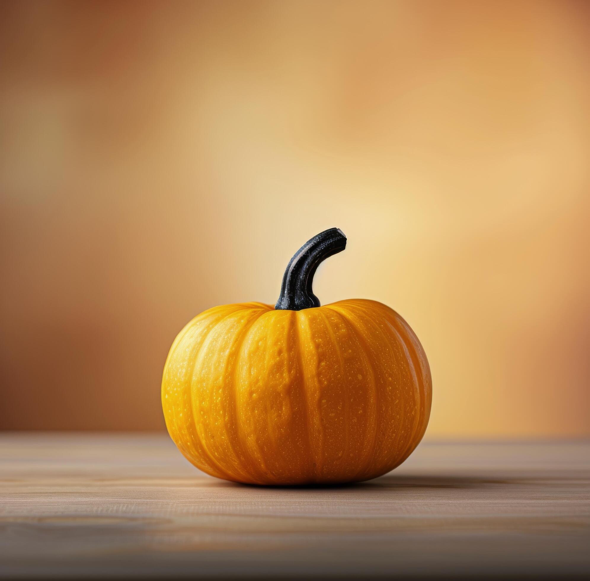 Single Pumpkin on White Table Against Orange Background Stock Free