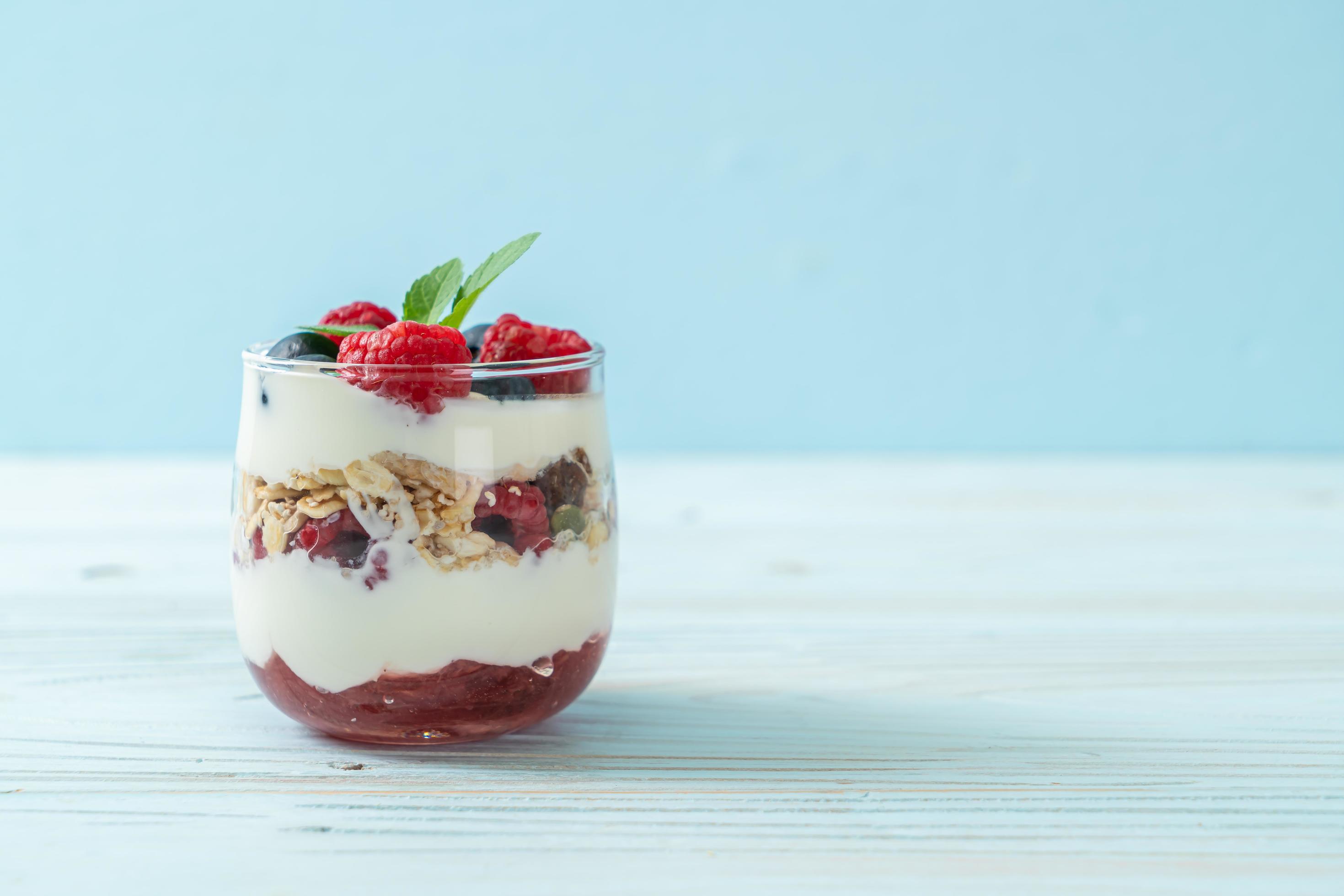 Homemade raspberry and blueberry with yogurt and granola – healthy food style Stock Free