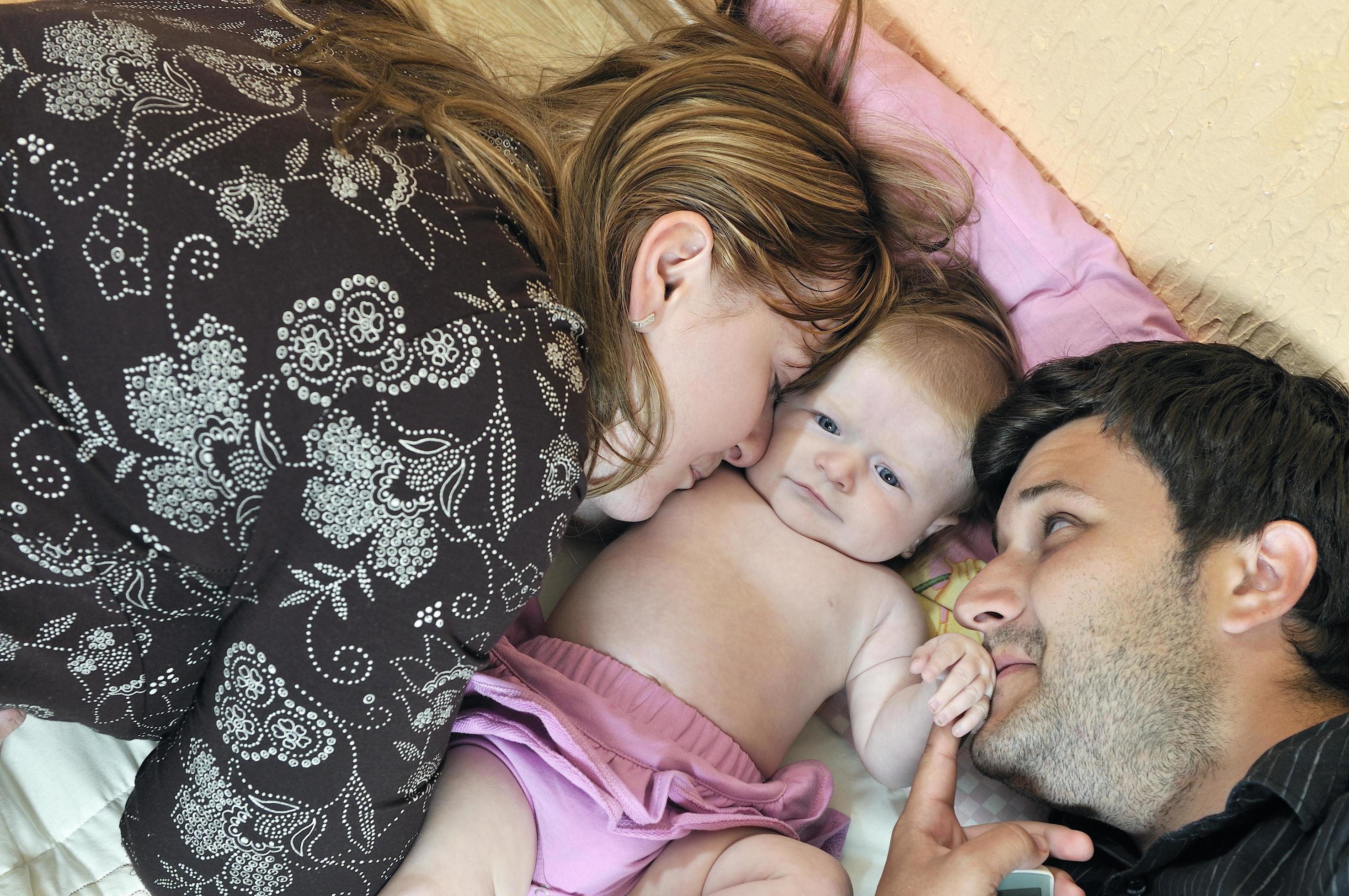 portrait of young family with cute little babby Stock Free