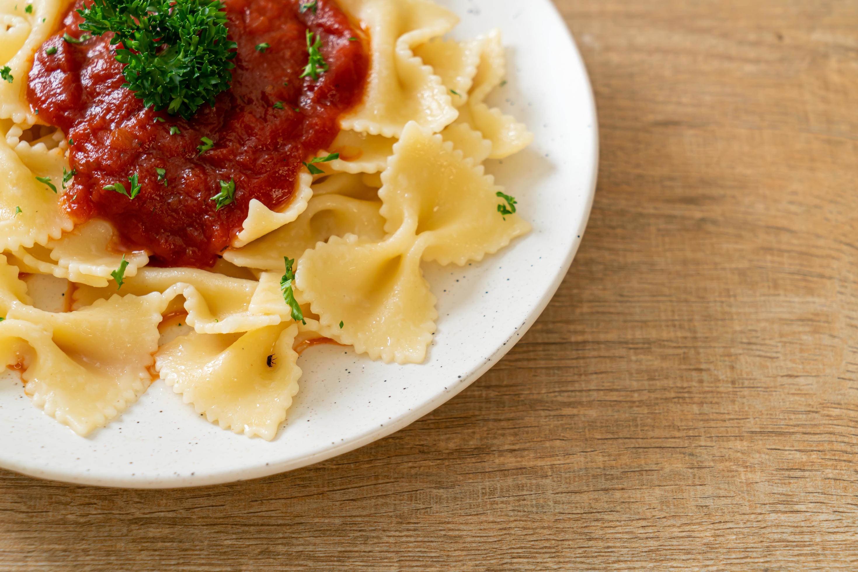 
									Farfalle pasta in tomato sauce with parsley – Italian food style Stock Free