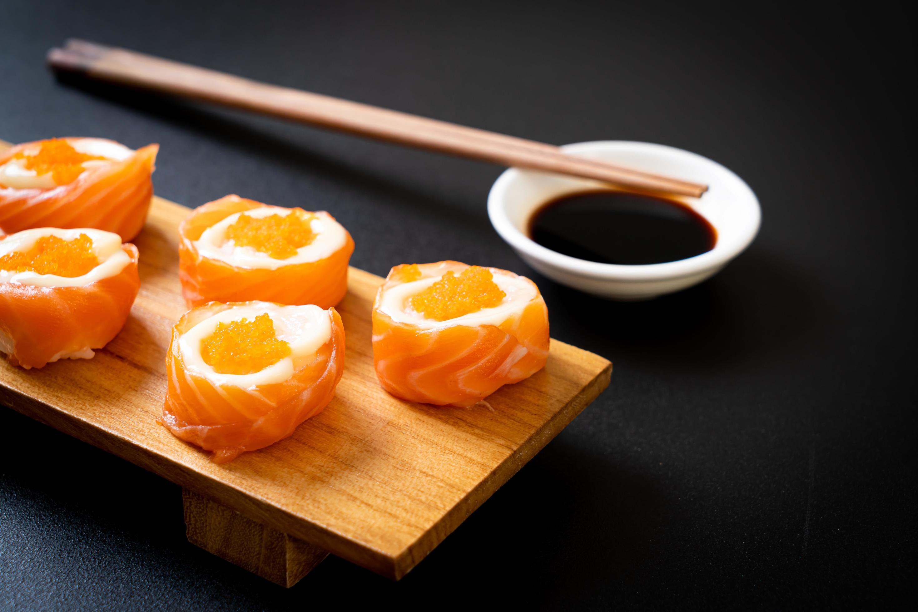 Fresh salmon sushi roll with mayonnaise and shrimp egg – Japanese food style Stock Free