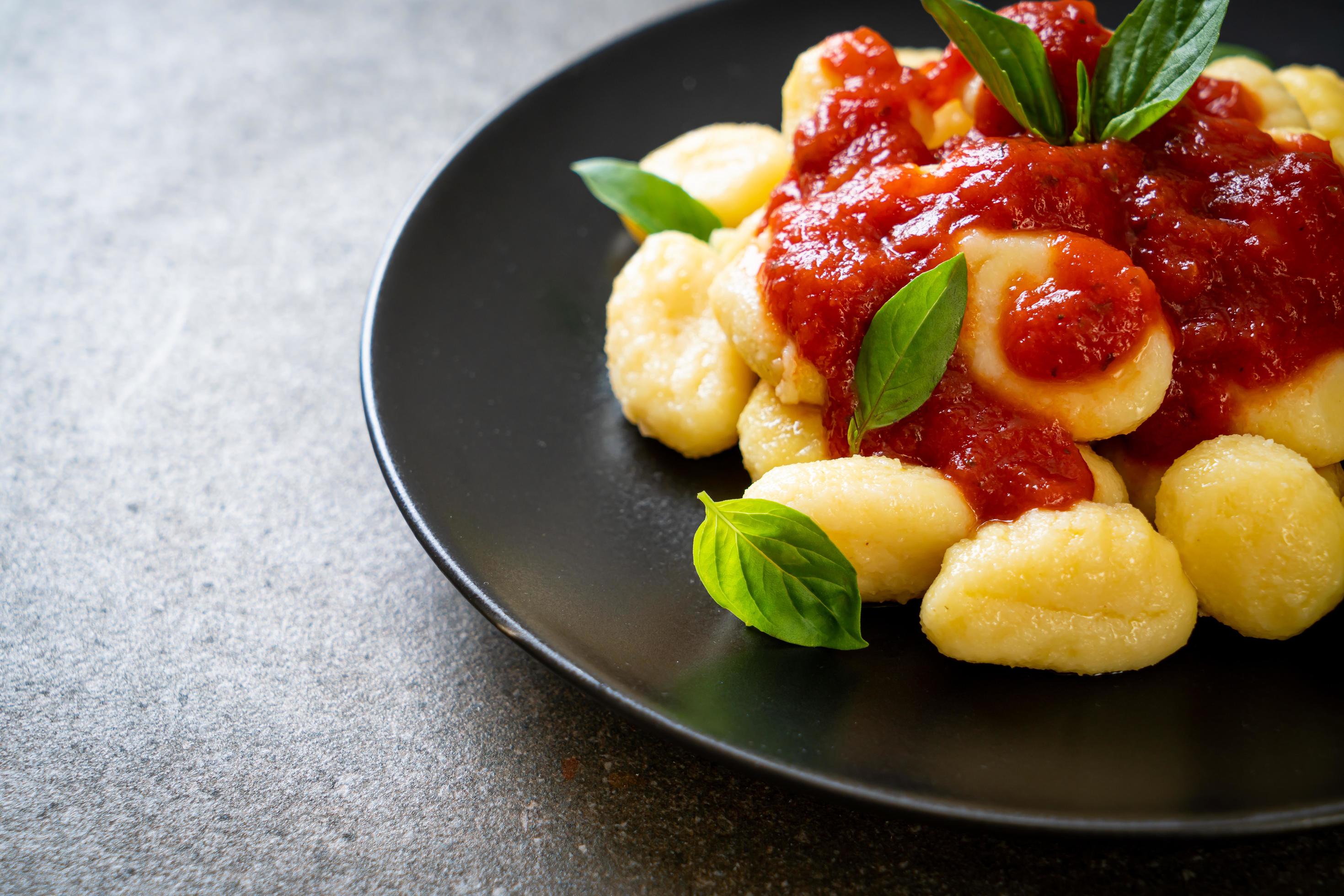 Gnocchi in tomato sauce with cheese – Italian food style Stock Free