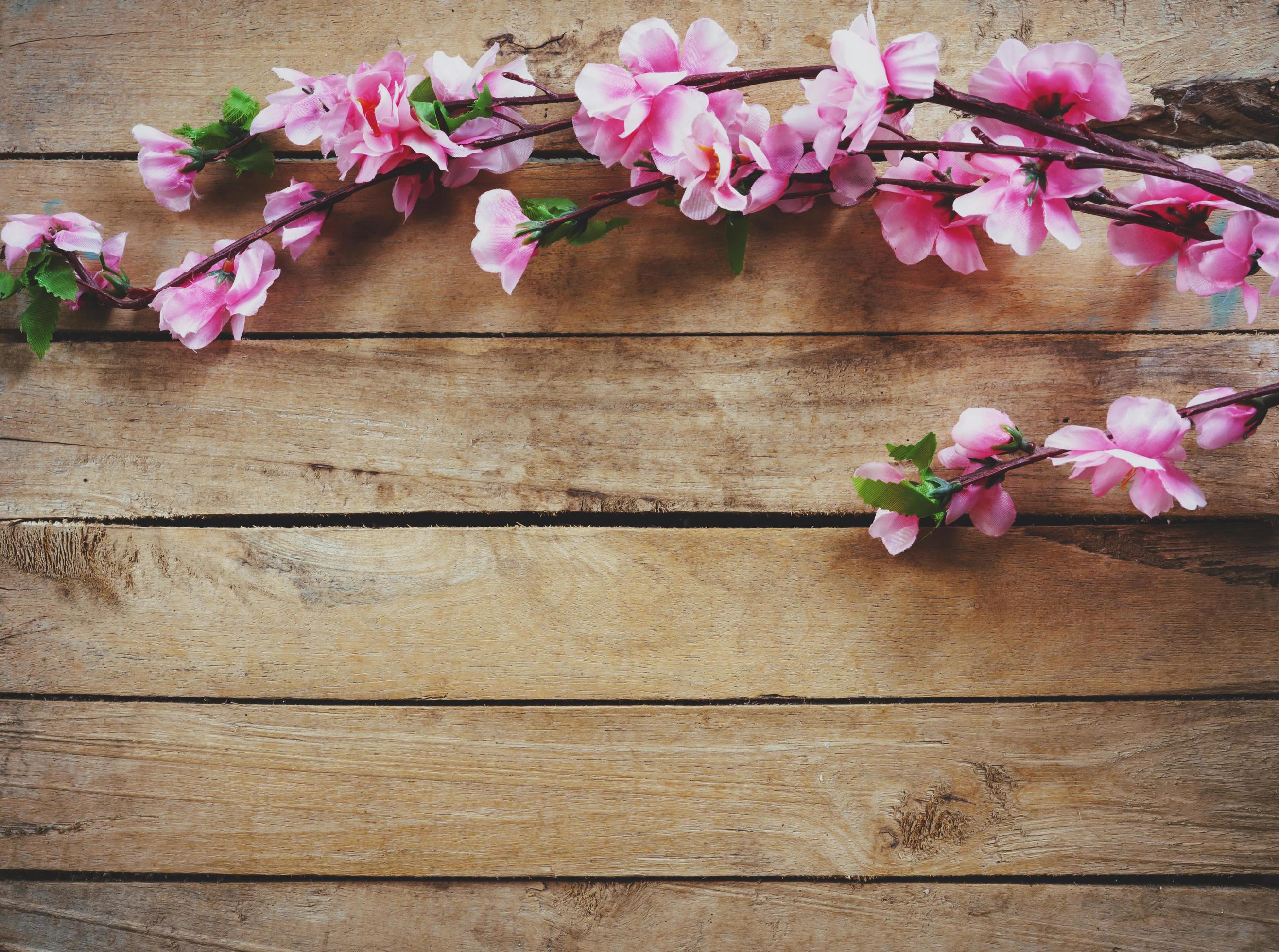 Cherry blossom and Artificial flowers on vintage wooden background with copy space. Stock Free