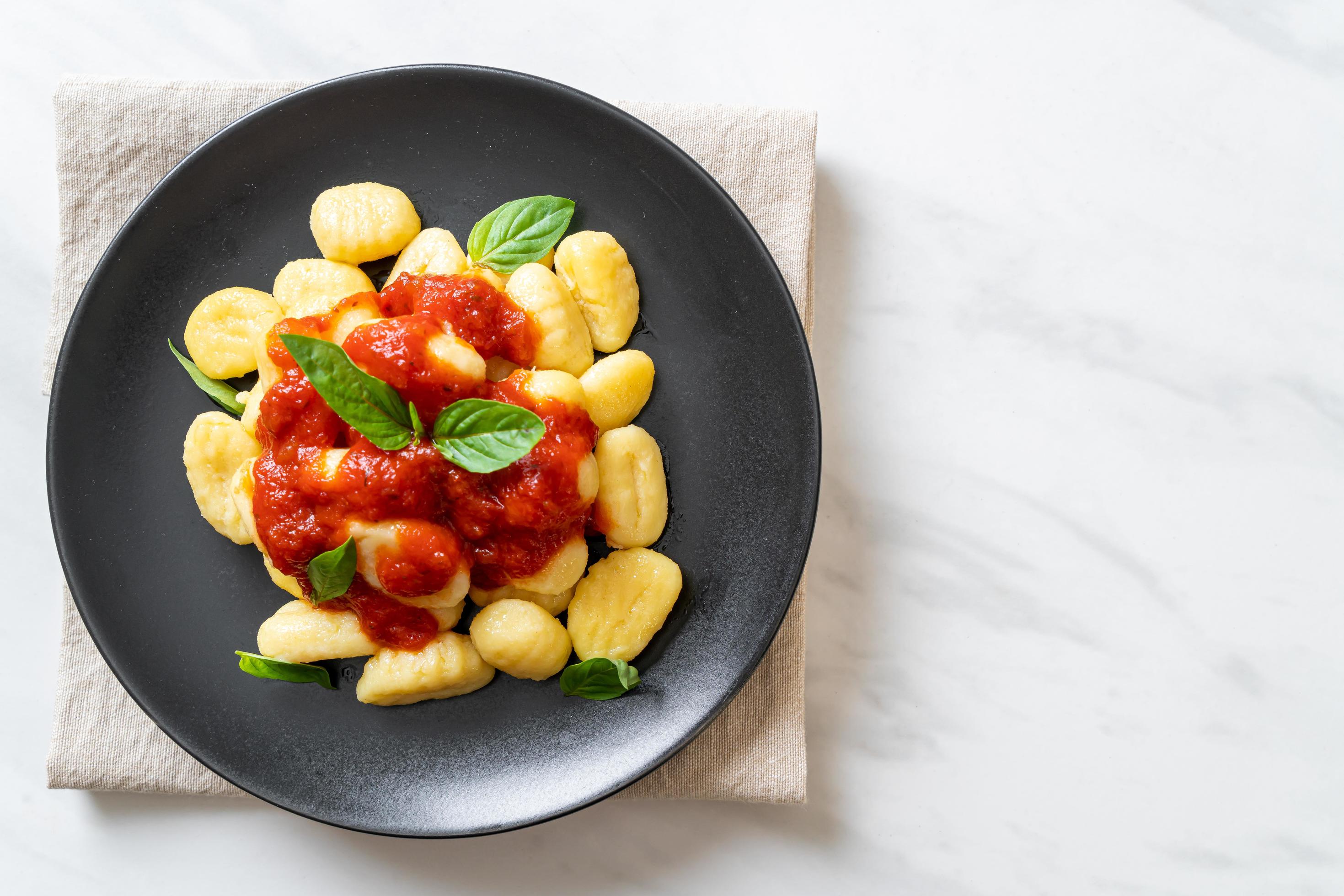 Gnocchi in tomato sauce with cheese – Italian food style Stock Free