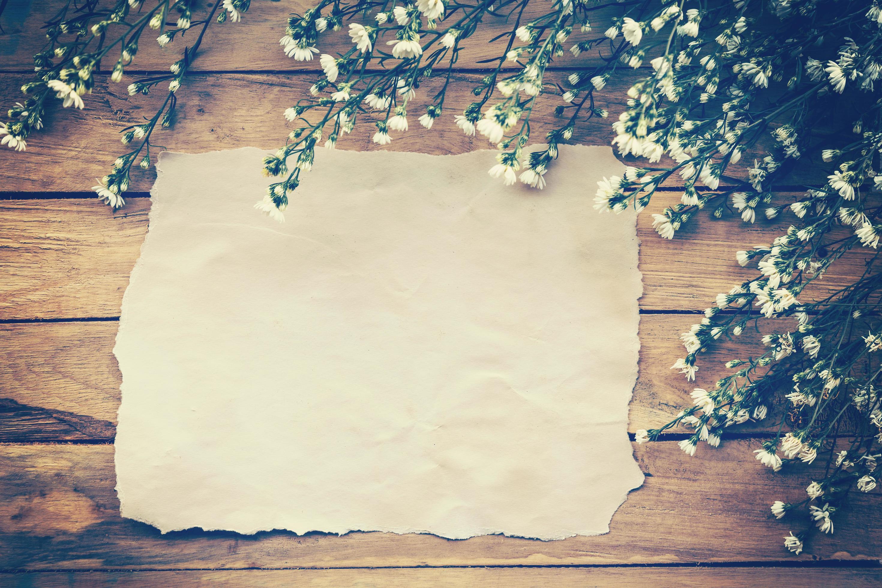 Flowers and old paper on wood texture background with copyspace. Vintage style. Stock Free