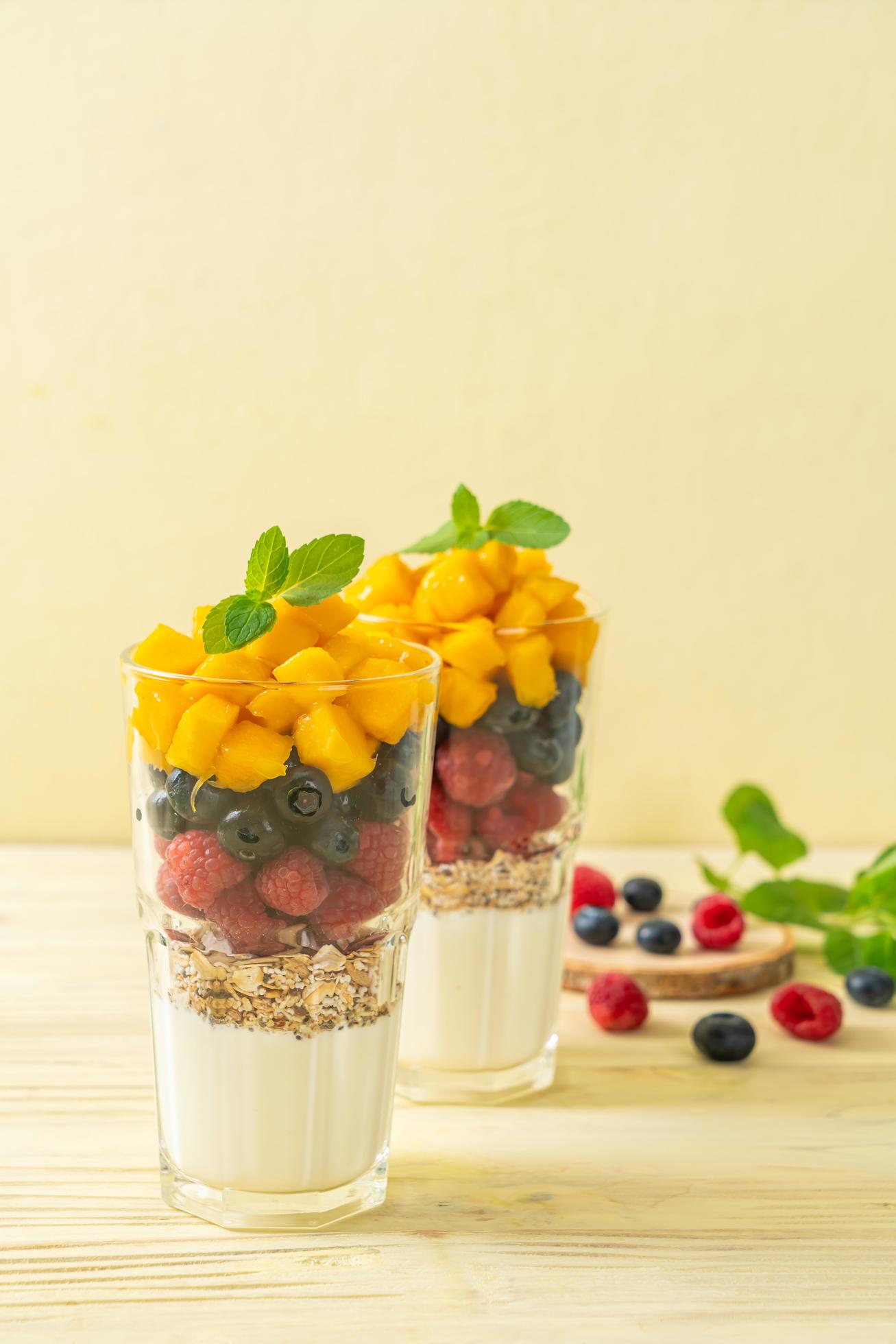 Homemade fresh mango and fresh raspberry with yogurt and granola – healthy food style Stock Free