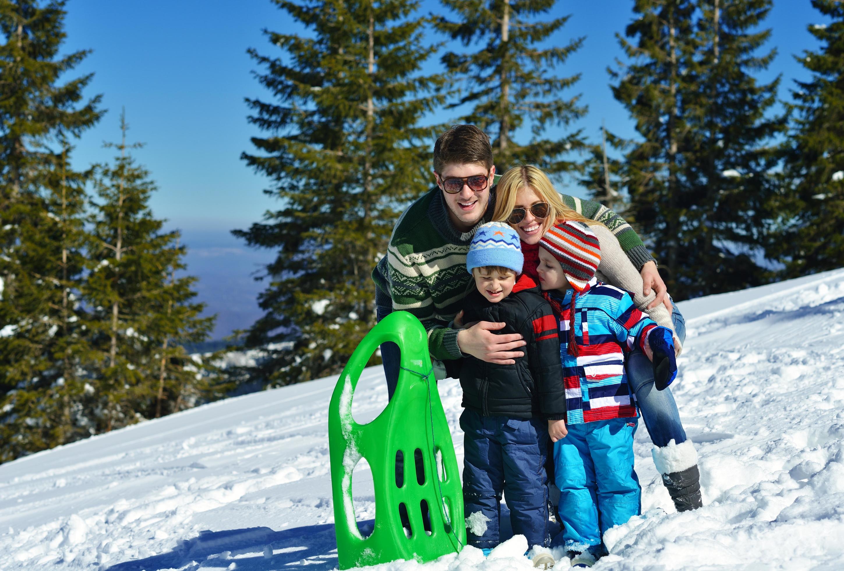 family having fun on fresh snow at winter Stock Free