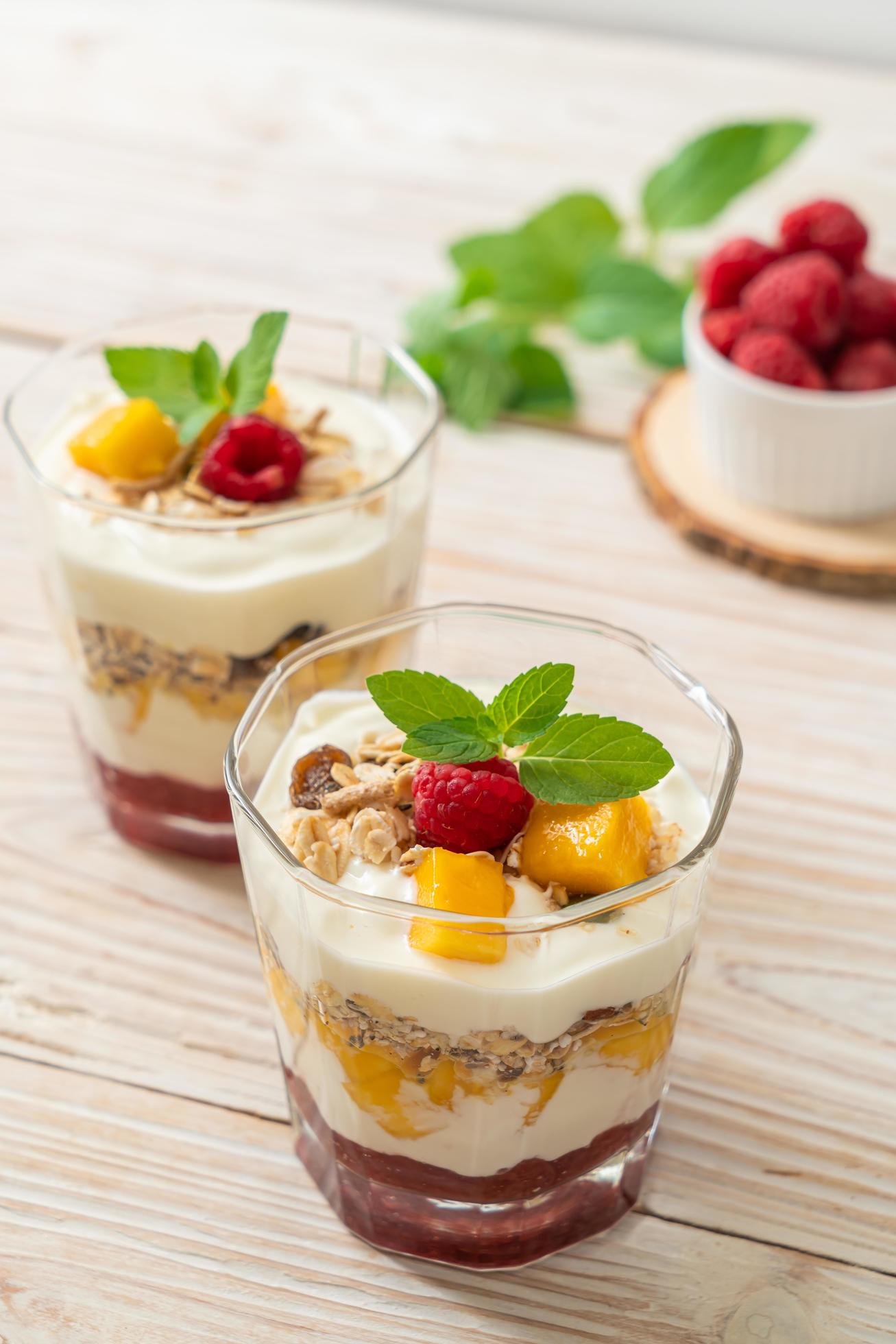 Homemade fresh mango and fresh raspberry with yogurt and granola – healthy food style Stock Free