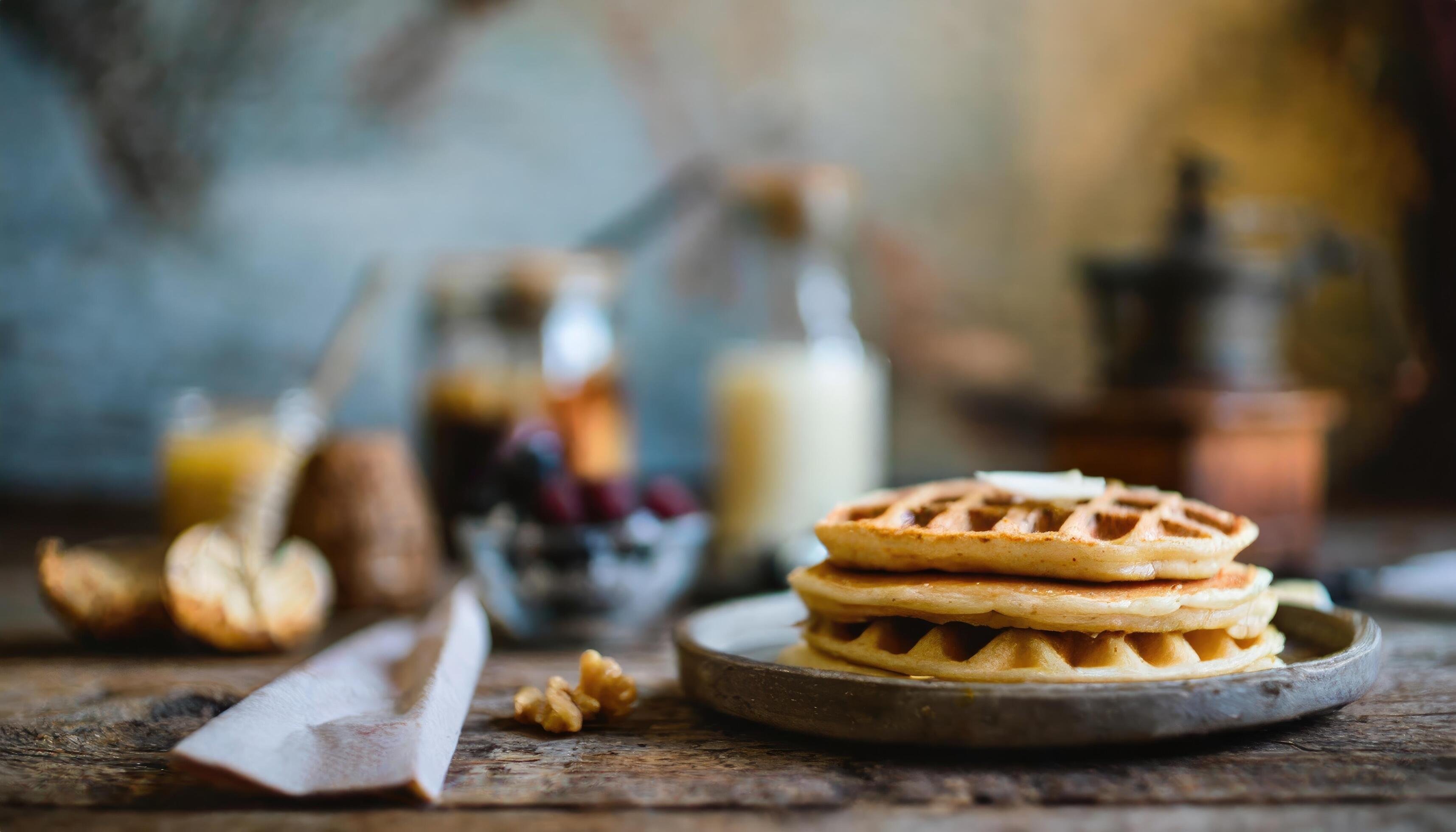 Copy Space image of Delicious viennese waffles with maple syrup drizzle and blackberry on dark brown wood background. Stock Free