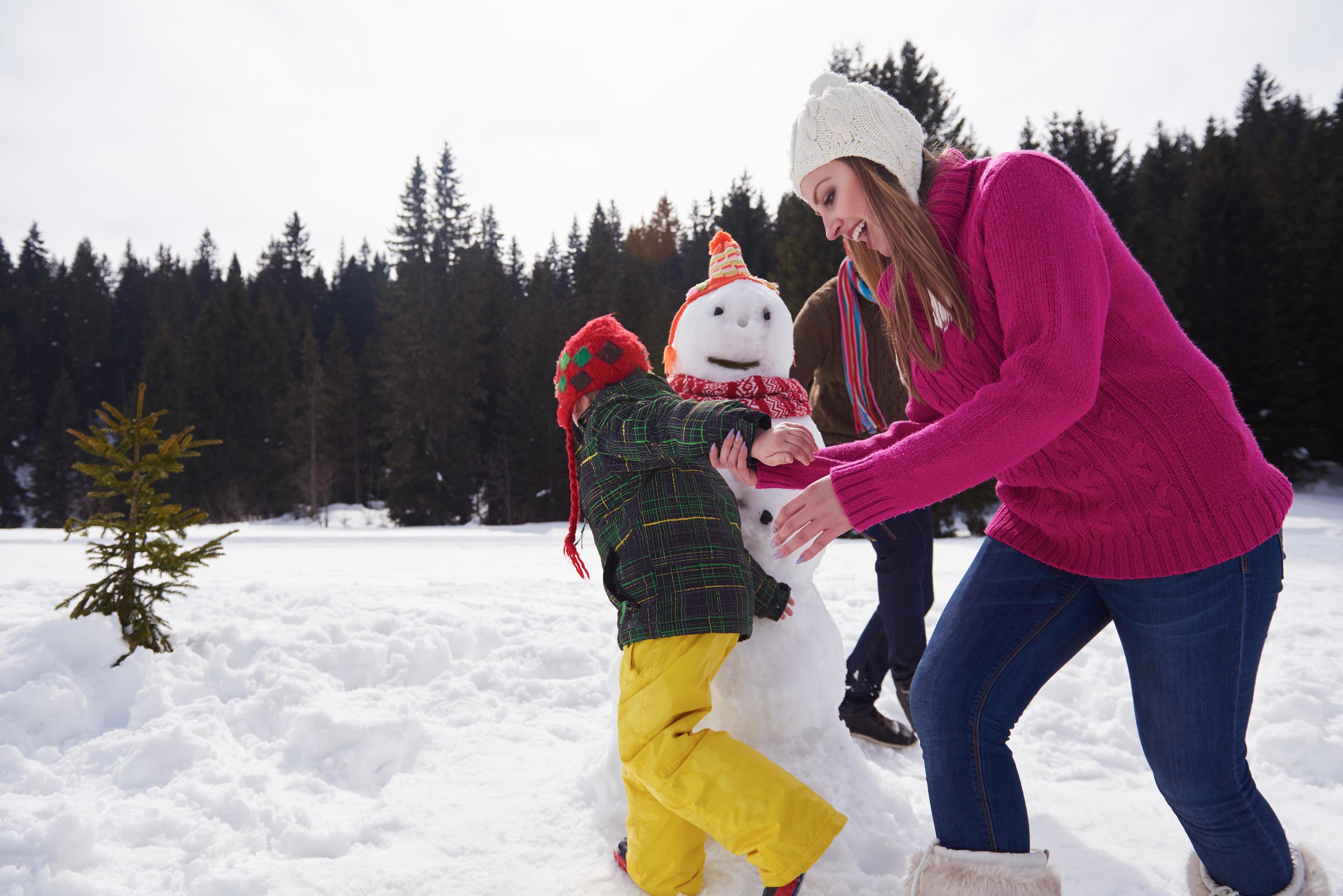 happy family building snowman Stock Free