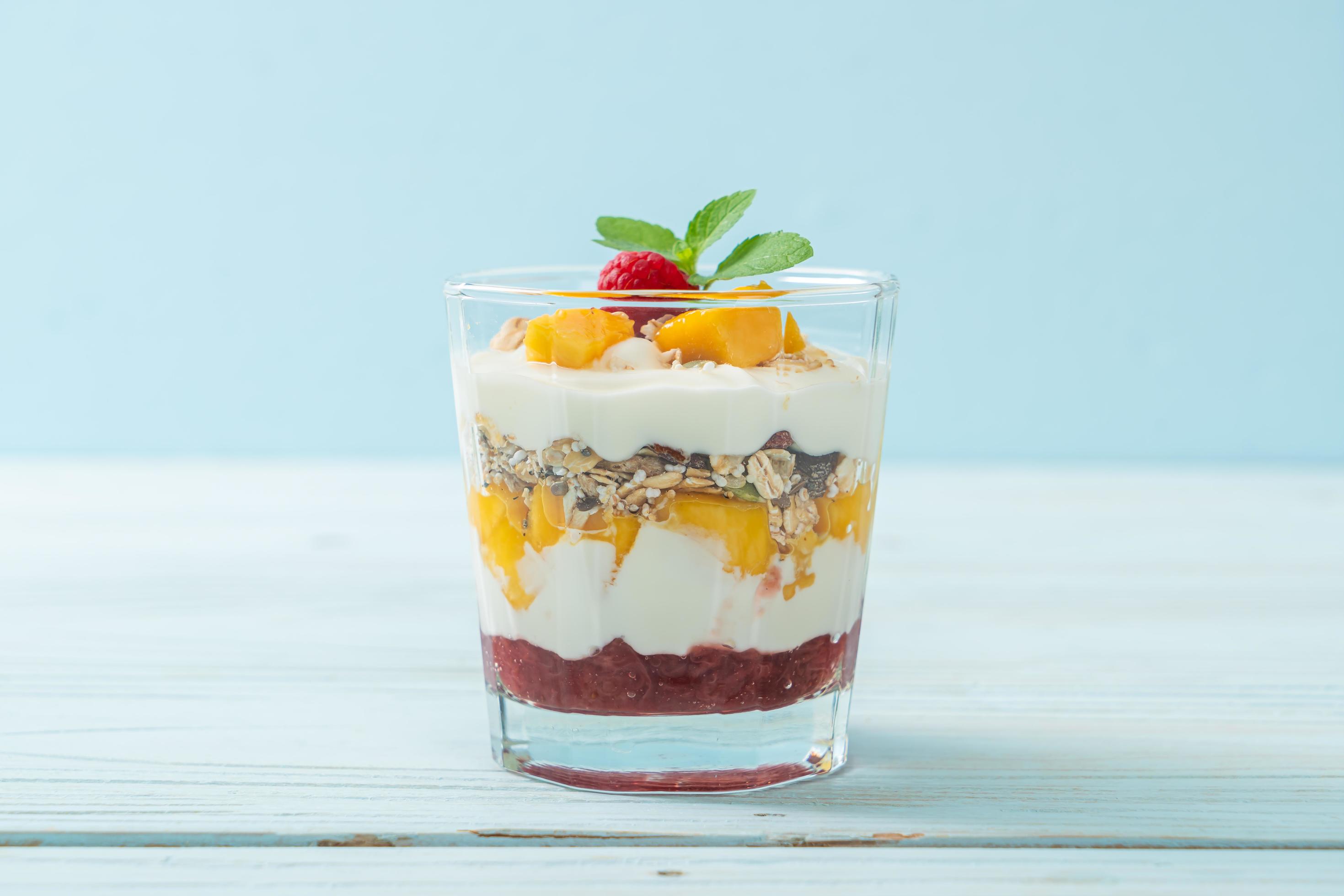 Homemade fresh mango and fresh raspberry with yogurt and granola – healthy food style Stock Free