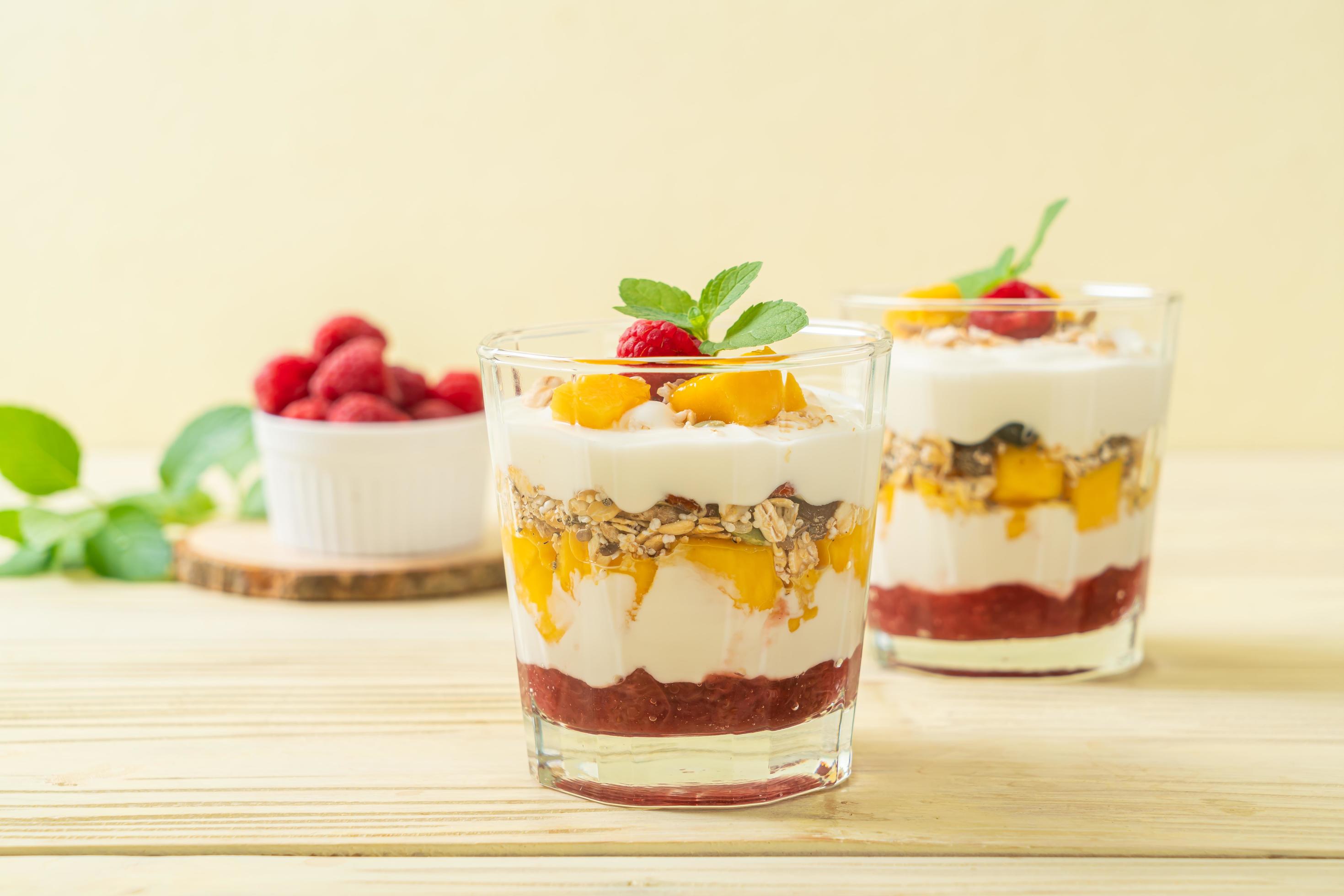 Homemade fresh mango and fresh raspberry with yogurt and granola – healthy food style Stock Free