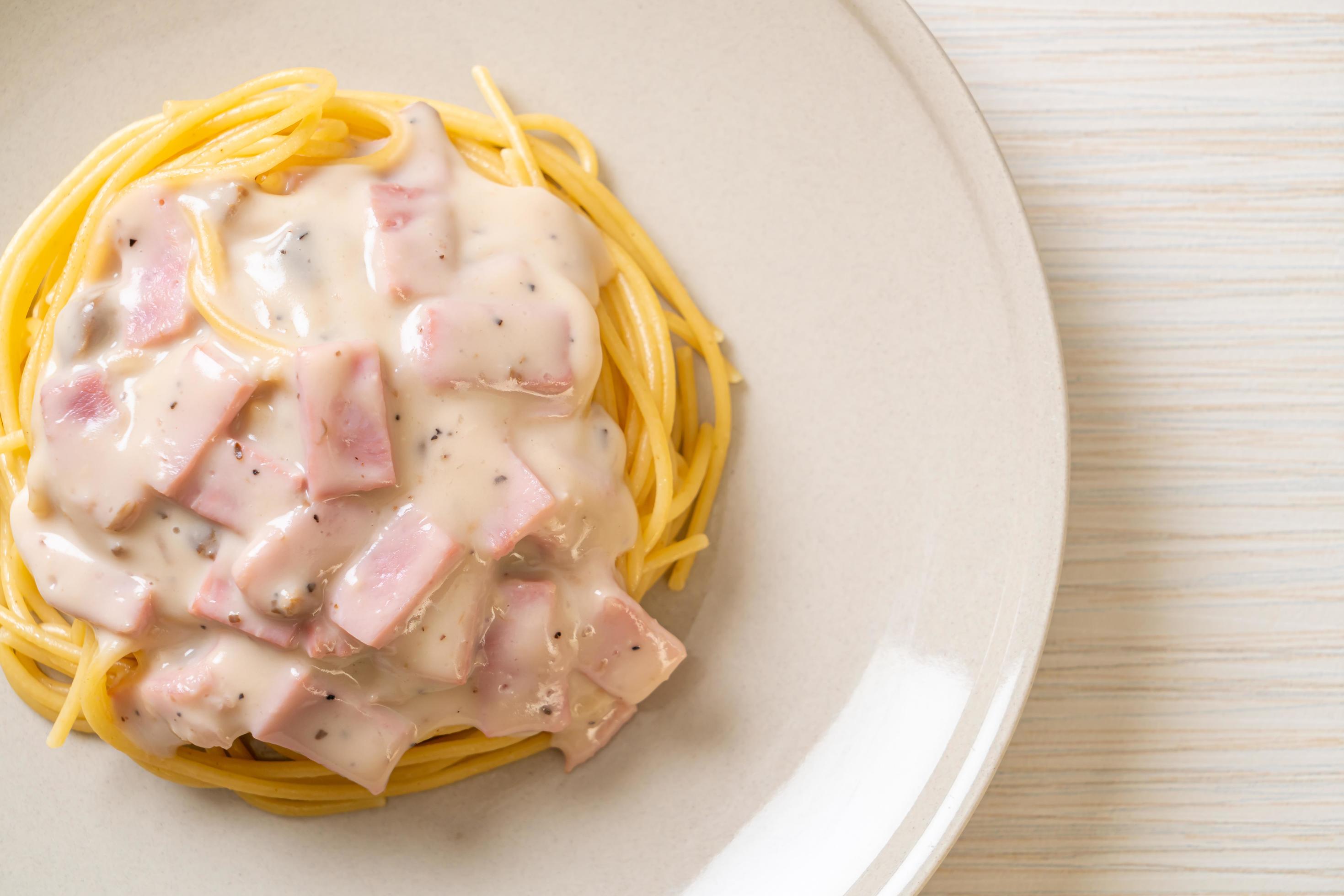 Homemade spaghetti white cream sauce with ham – Italian food style Stock Free