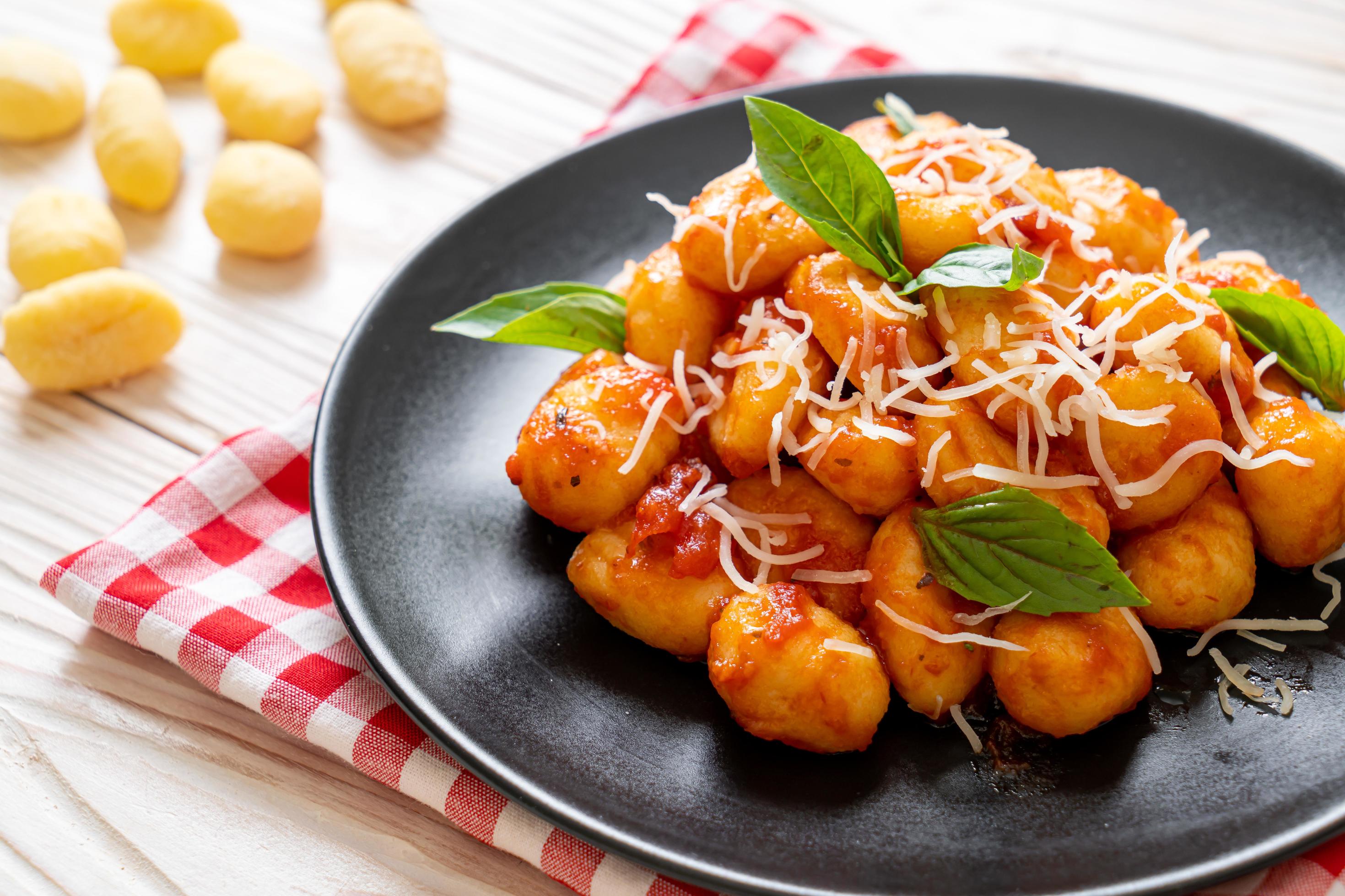 Gnocchi in tomato sauce with cheese – Italian food style Stock Free