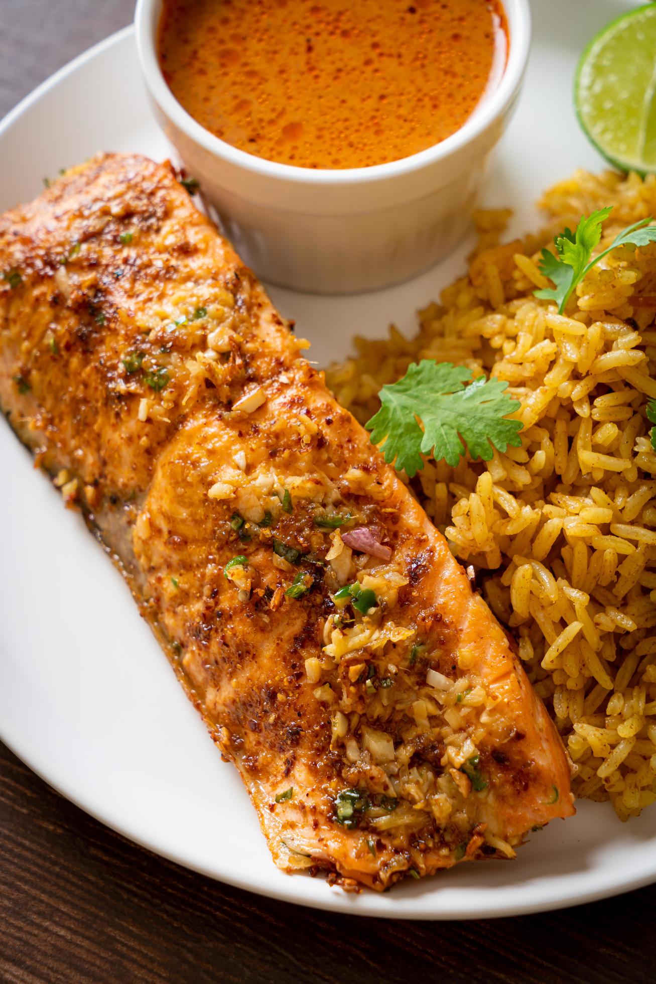 Pan-seared salmon tandoori with masala rice – Muslim food style Stock Free