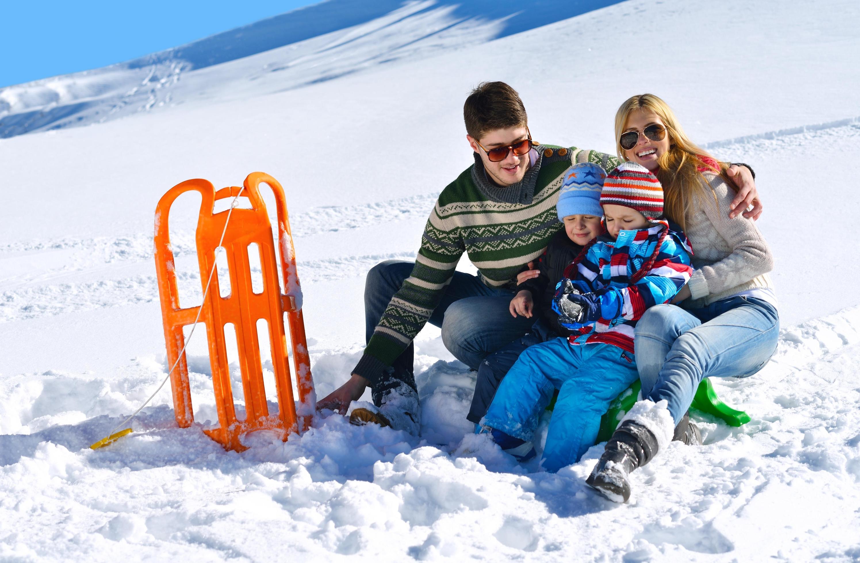 family having fun on fresh snow at winter Stock Free