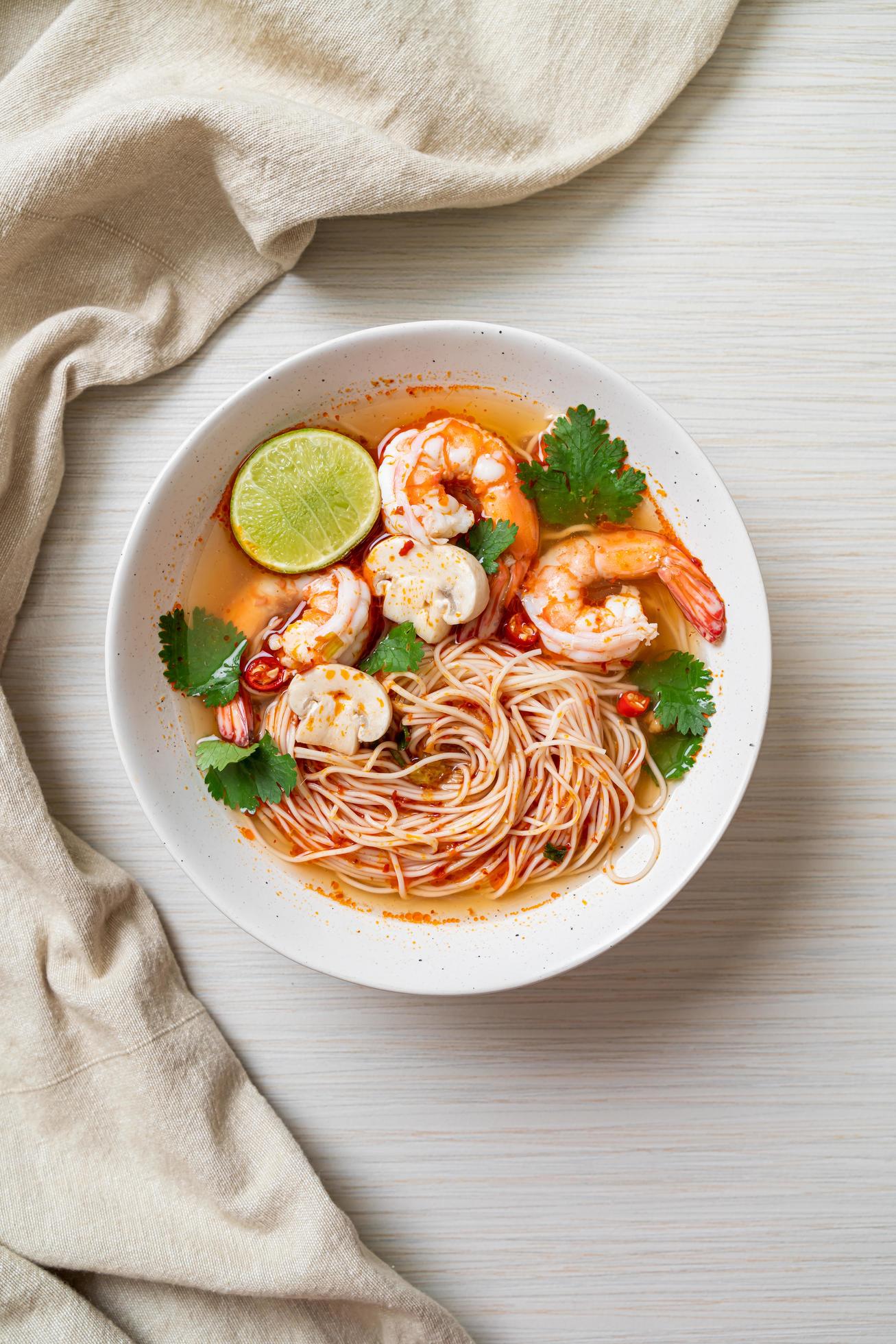 Noodles with spicy soup and shrimps or Tom Yum Kung – Asian food style Stock Free