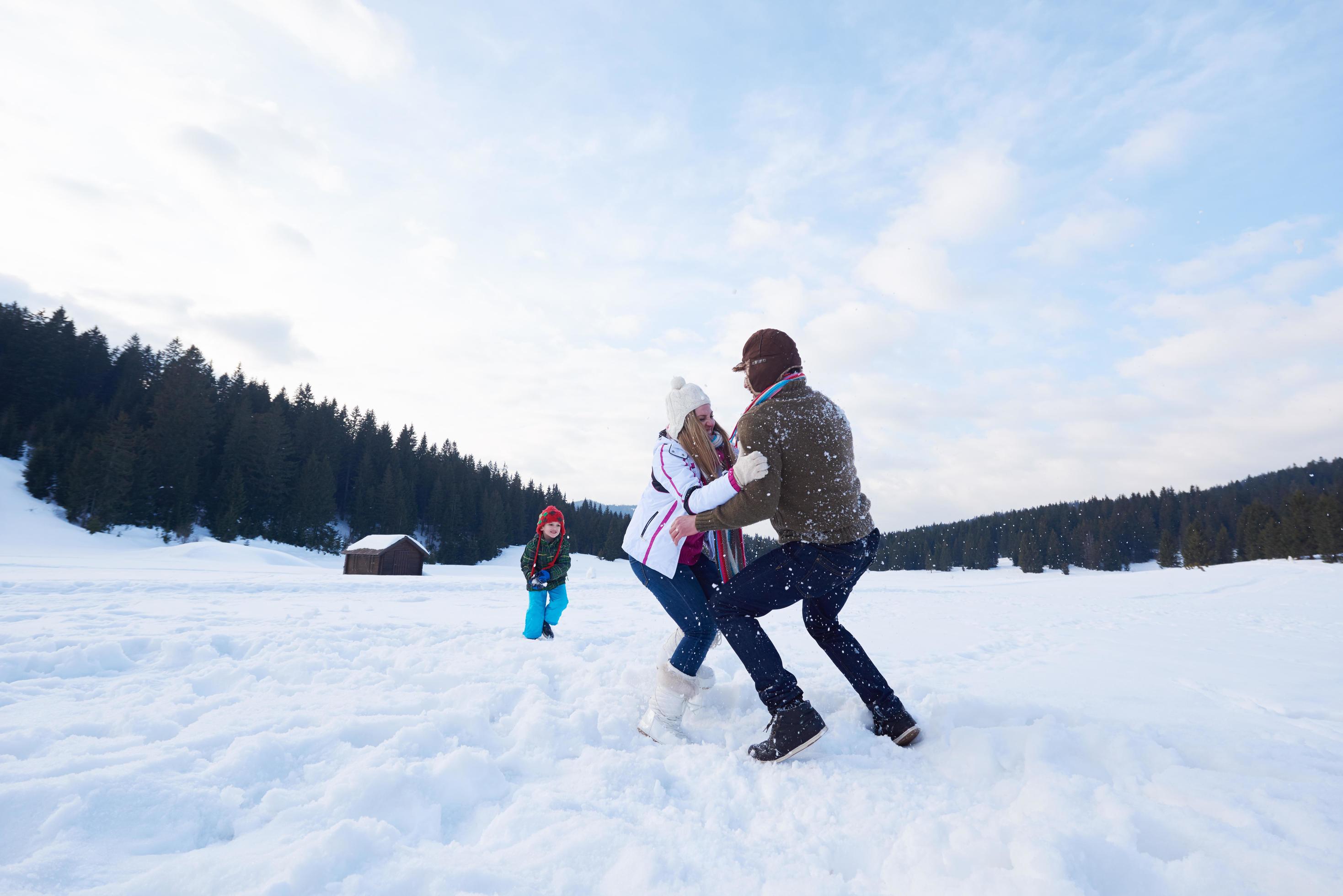 happy family playing together in snow at winter Stock Free