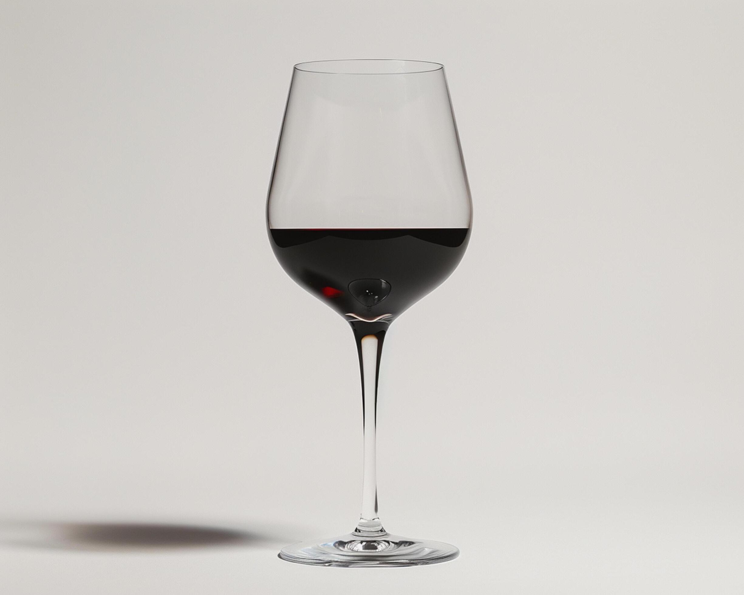 a wine glass with a red liquid in it Stock Free