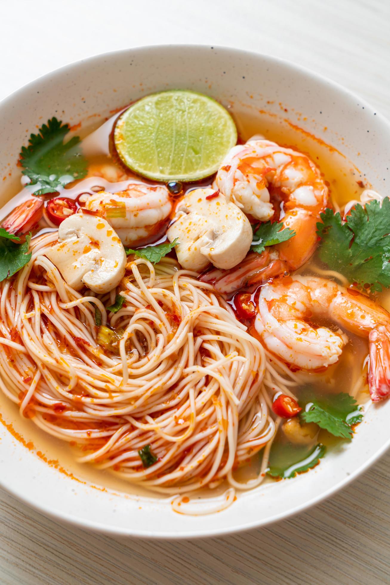 
									Noodles with spicy soup and shrimps in white bowl, or Tom Yum Kung – Asian food style Stock Free