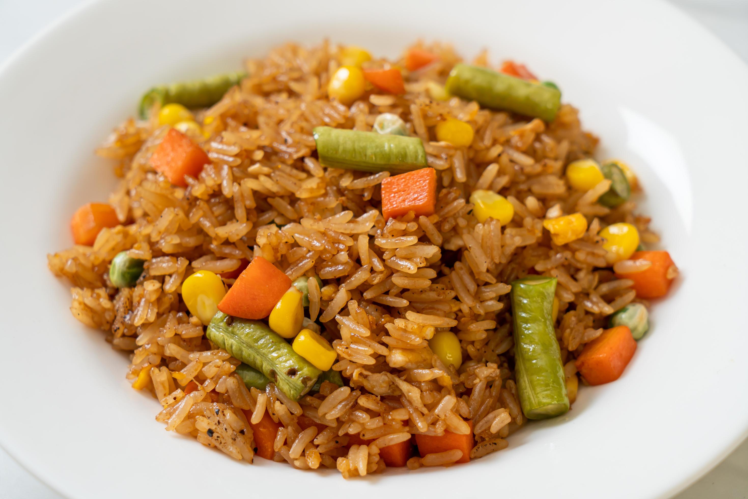 Fried rice with green peas, carrot and corn – vegetarian and healthy food style Stock Free