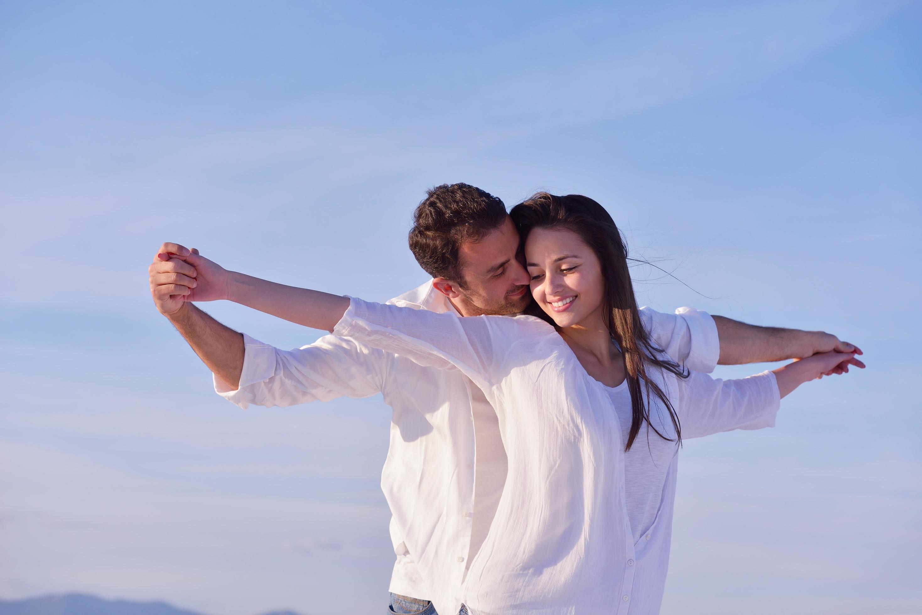 young couple on beach have fun Stock Free