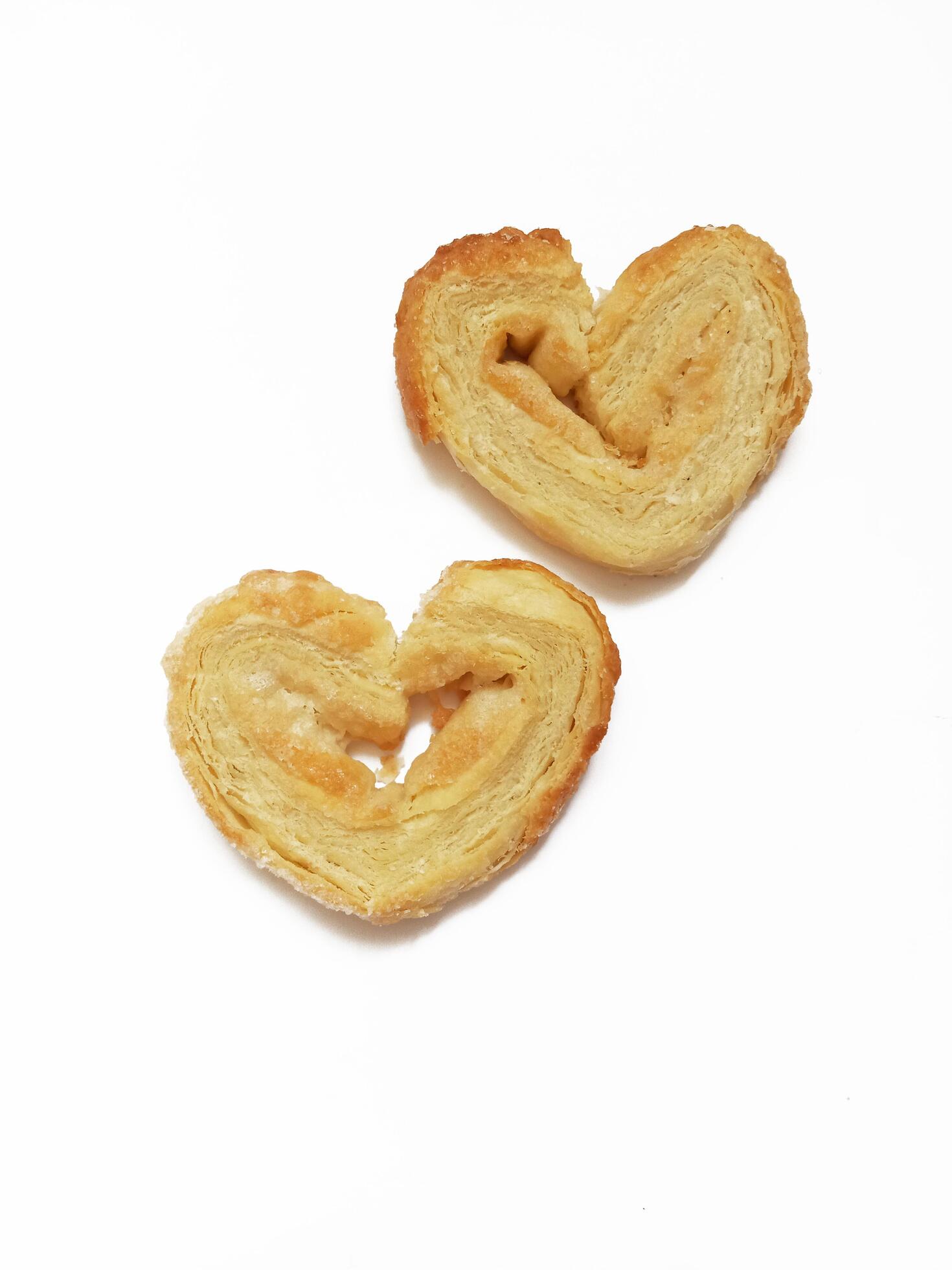 Sugar cookie curls puff pastry heart shape on white background Stock Free