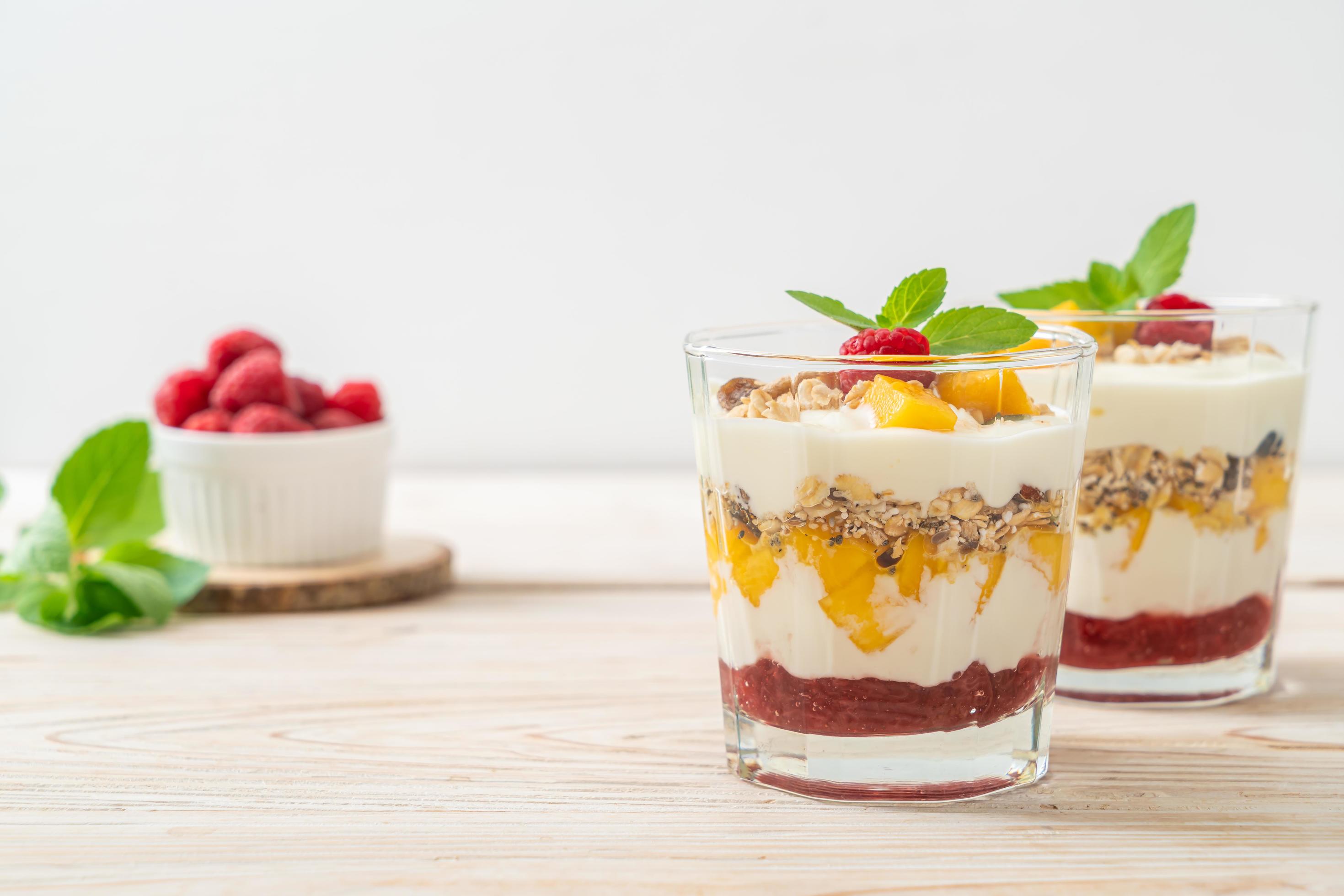 Homemade fresh mango and fresh raspberry with yogurt and granola – healthy food style Stock Free