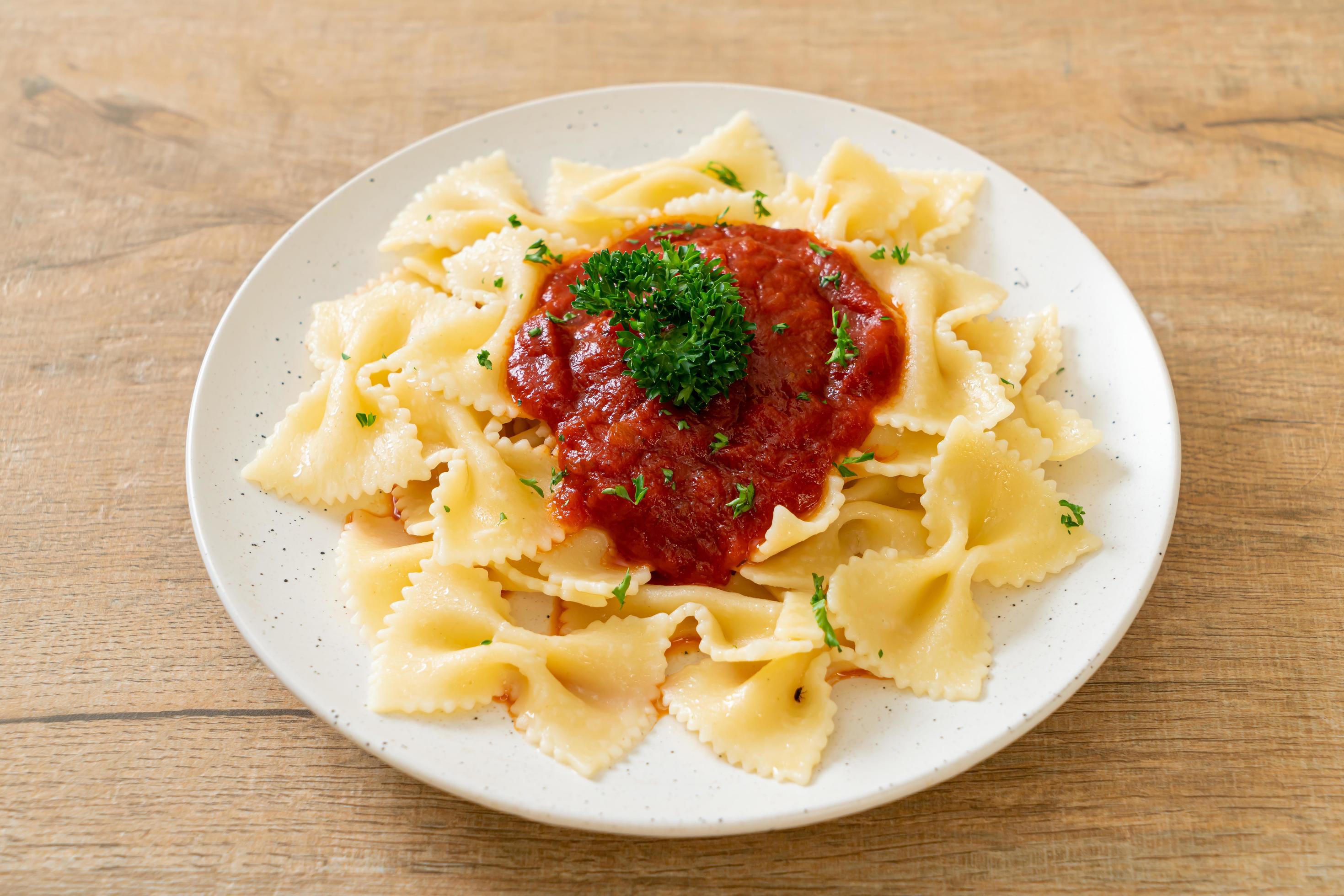 
									Farfalle pasta in tomato sauce with parsley – Italian food style Stock Free