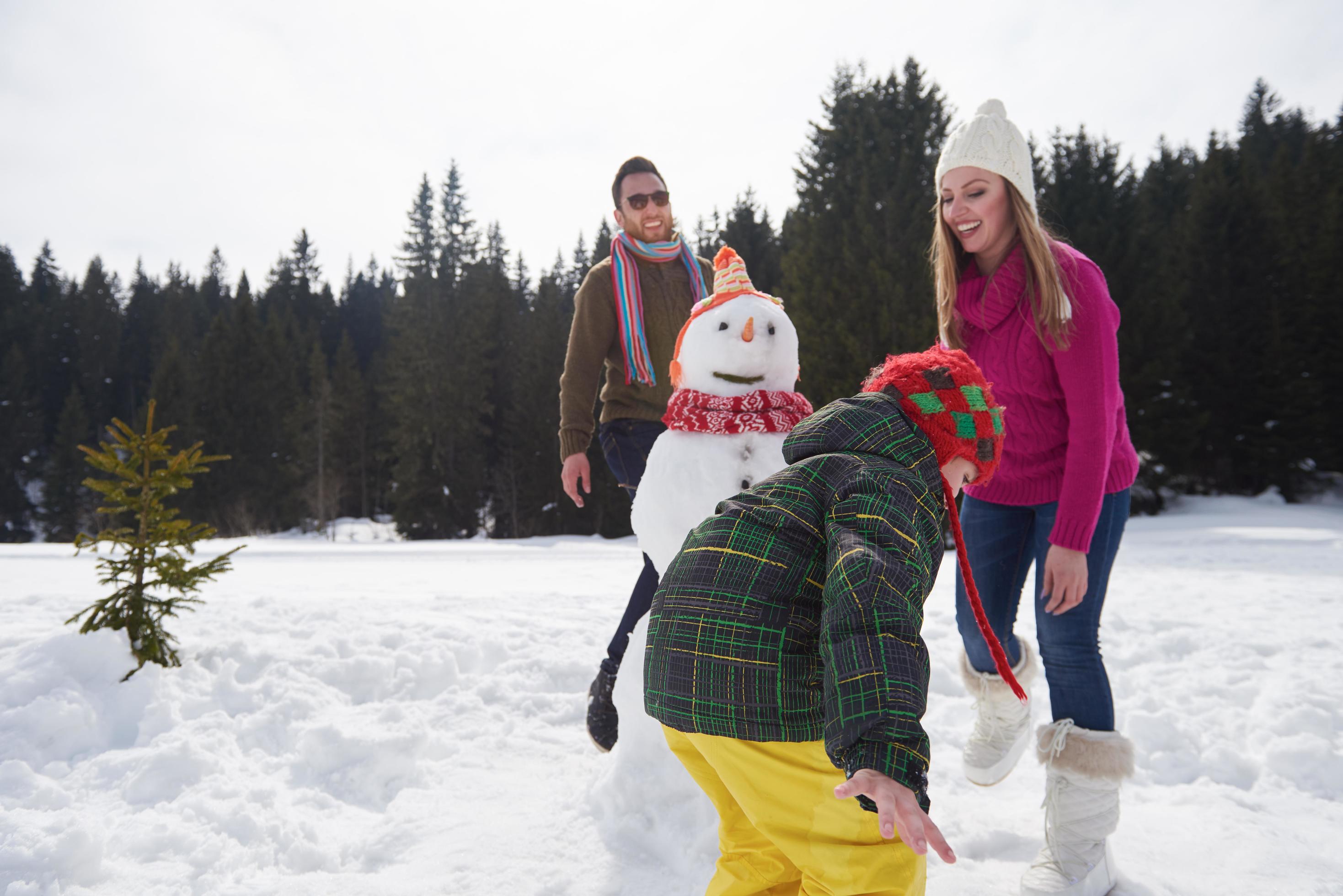 happy family building snowman Stock Free