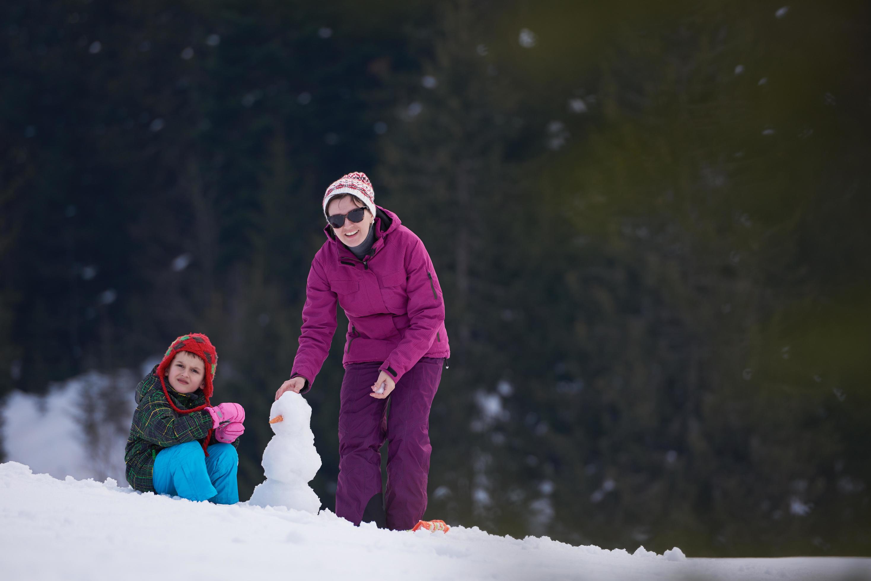 happy family building snowman Stock Free