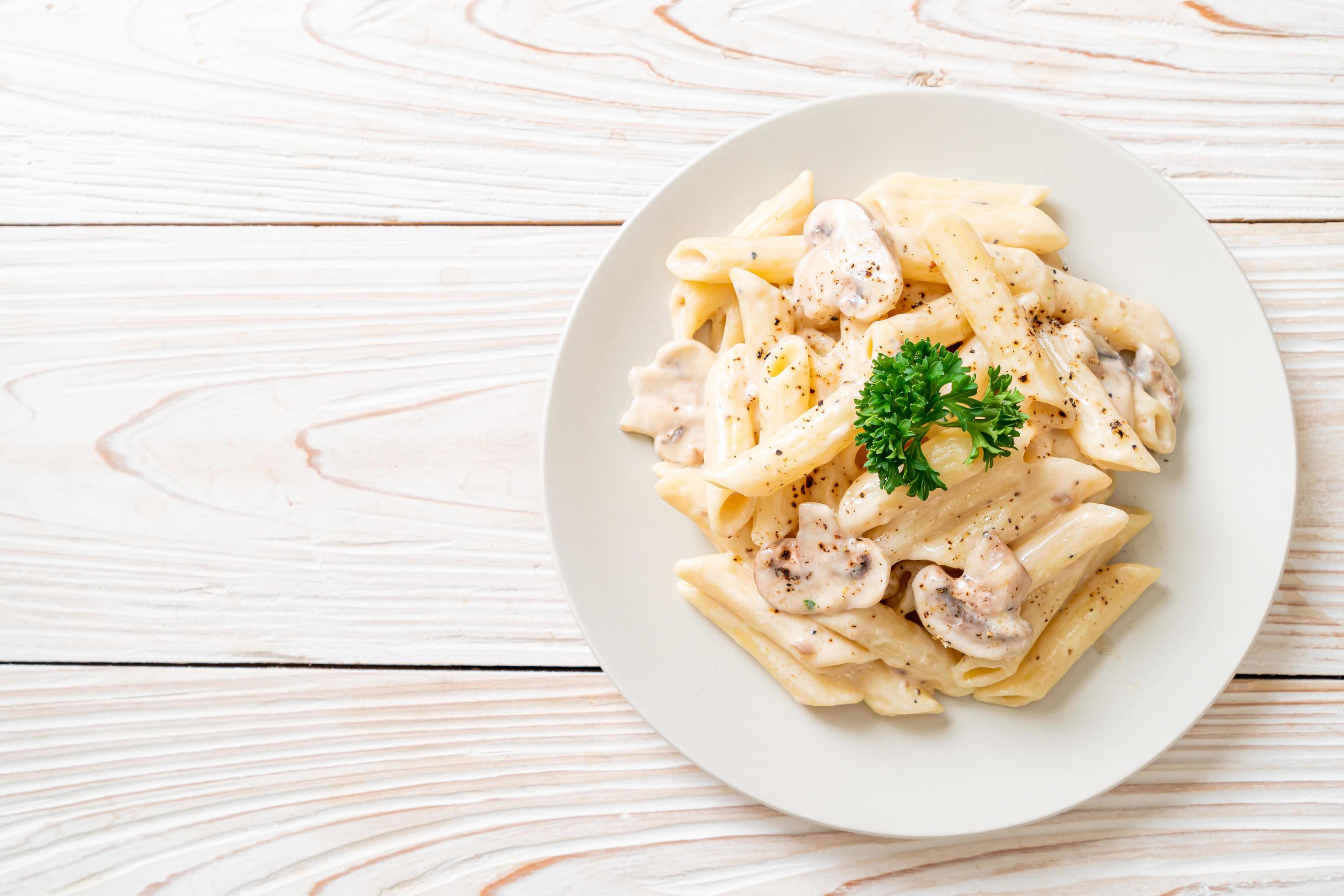 Penne pasta carbonara cream sauce with mushroom – Italian food style Stock Free