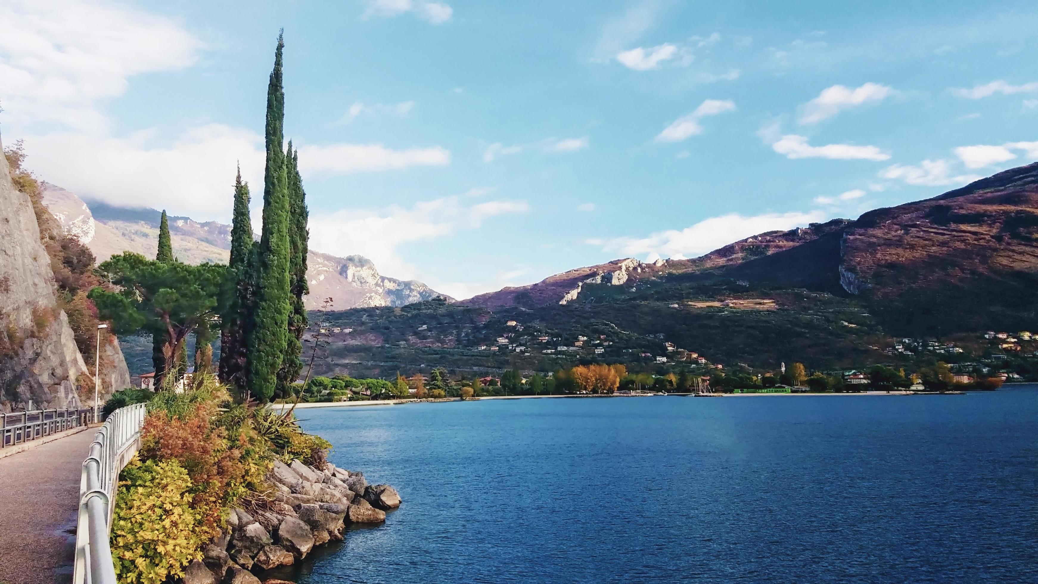 
									Colorful sailing boats in the harbor at mountain lake in autumn, Garda Lake, Italy Stock Free